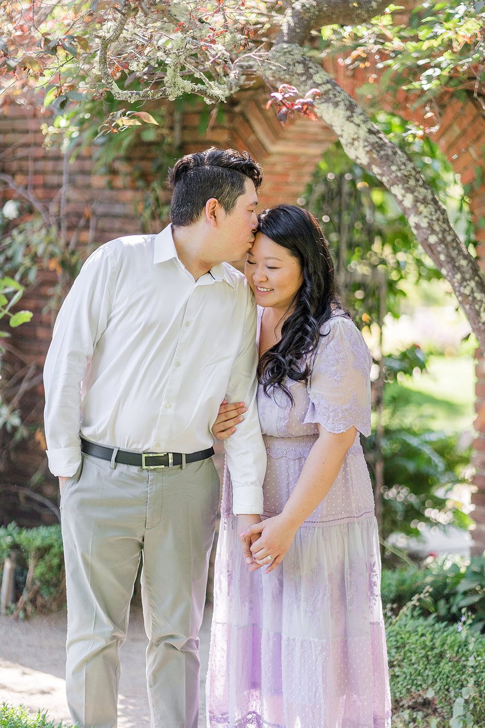 a bride and groom to be share an moment together during their filoli gardens engagement photos.