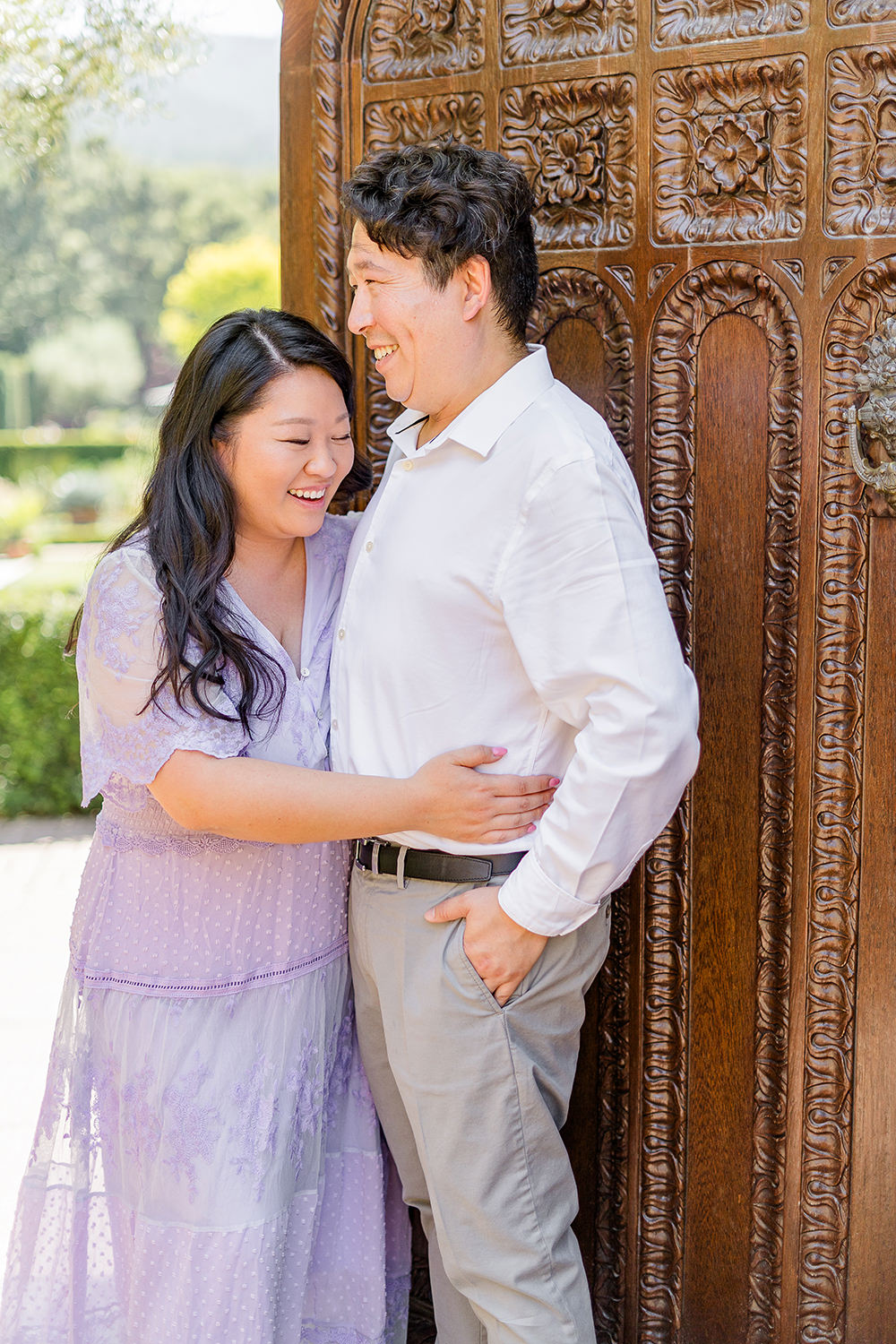 a bride and groom to be share a laugh together during their filoli gardens engagement photos.