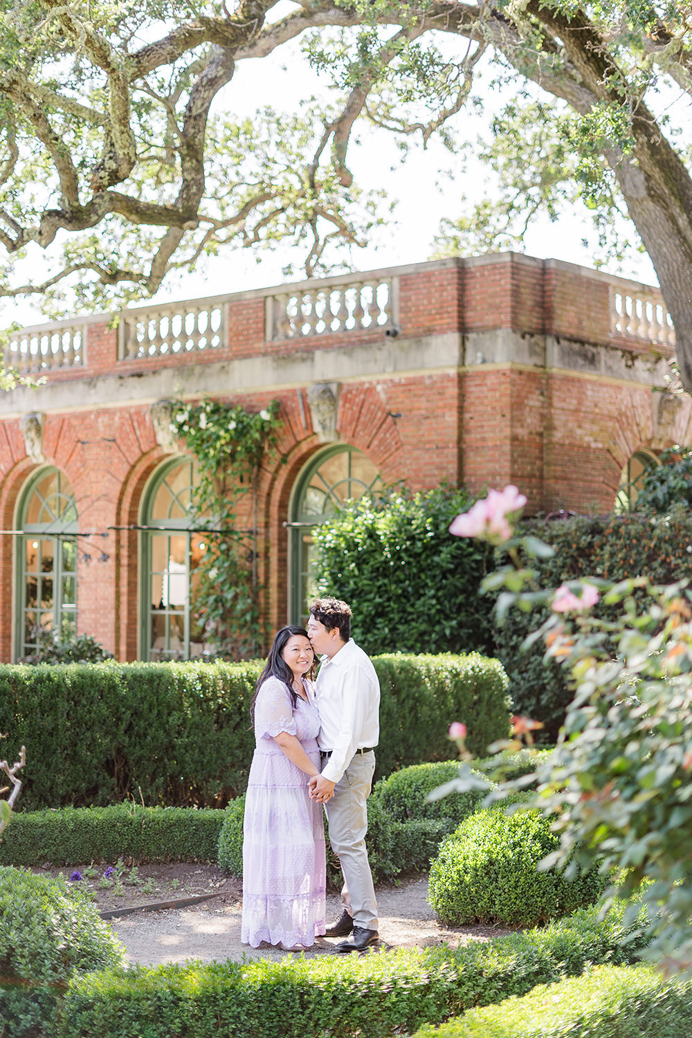 a bride and groom to be share an moment together during their filoli gardens engagement photos.