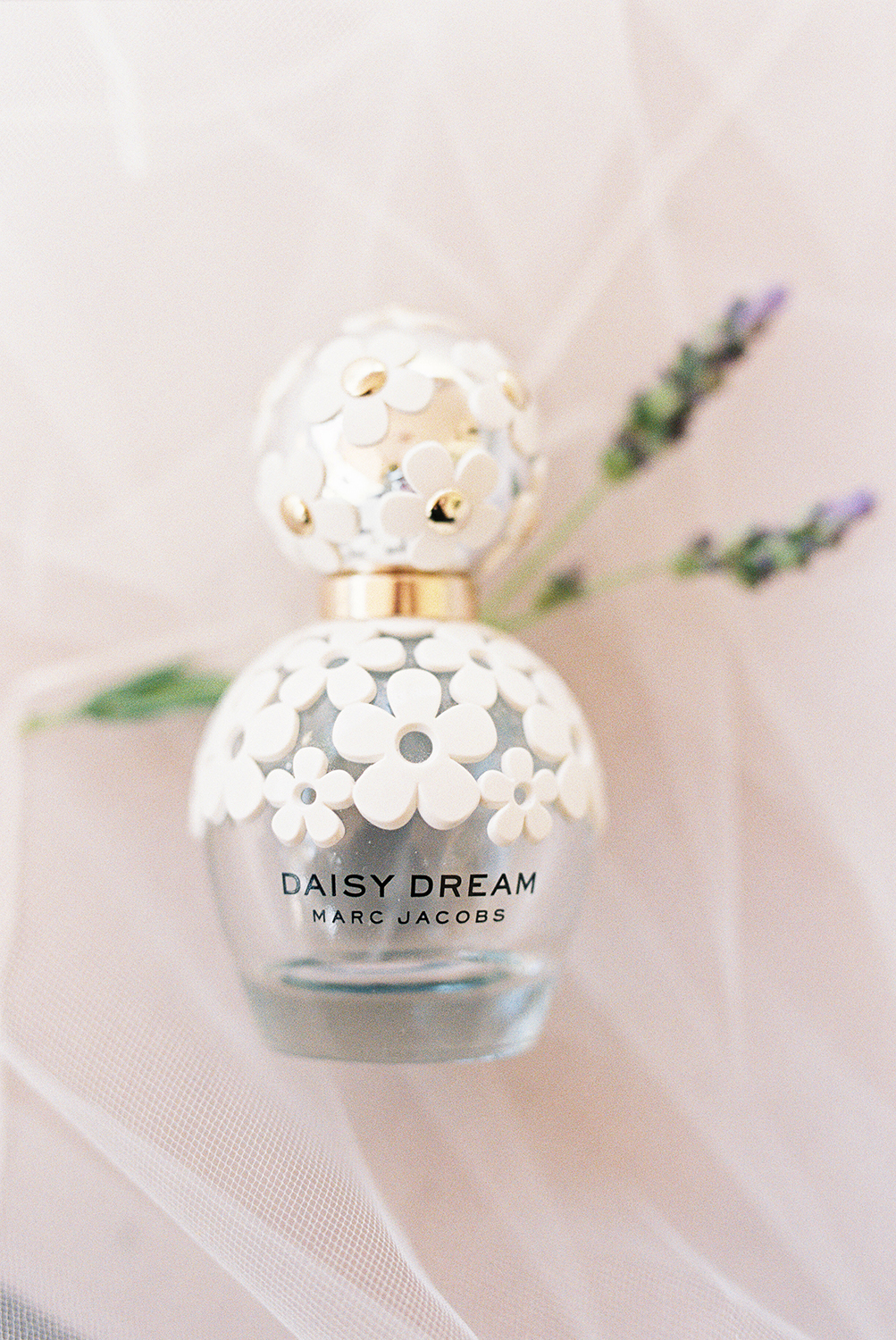 A brides perfume bottle of Daisy Dream by Marc Jacobs photographed on Kodak Portra 400 Film 