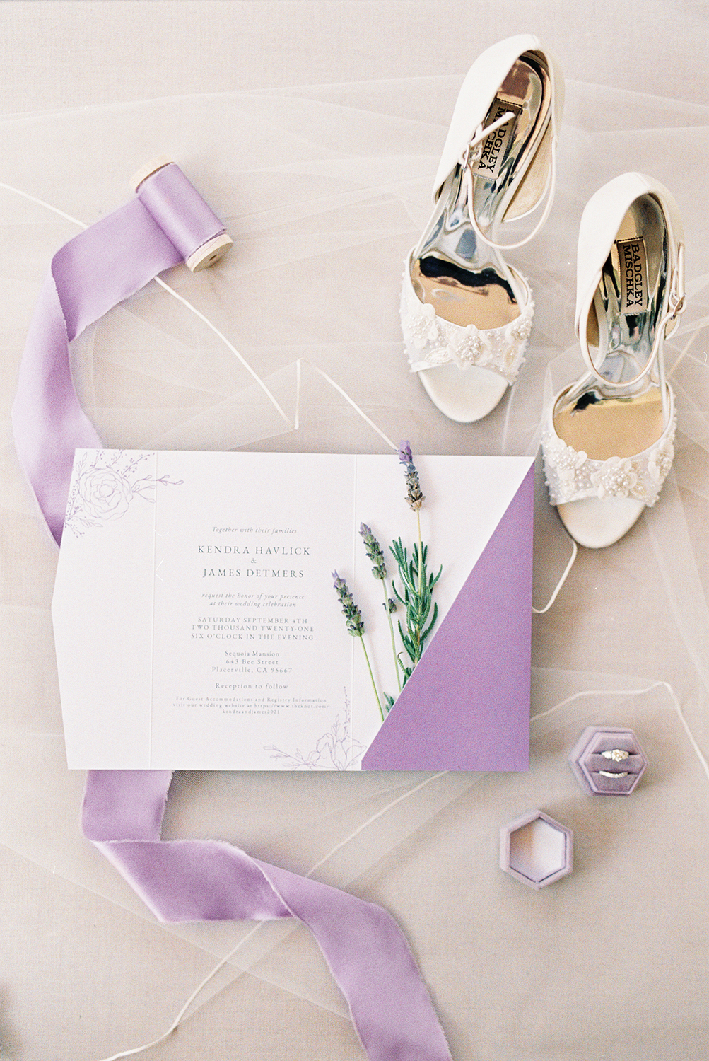 A wedding invitation featuring real lavender surrounded by bridal details photographed on Kodak Portra 400 Film 