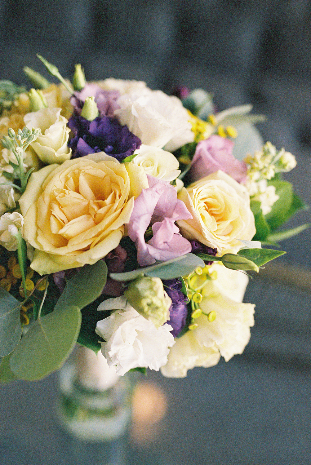 a bridal bouquet featuring yellow and purple florals photographed on Kodak Portra 400 Film 