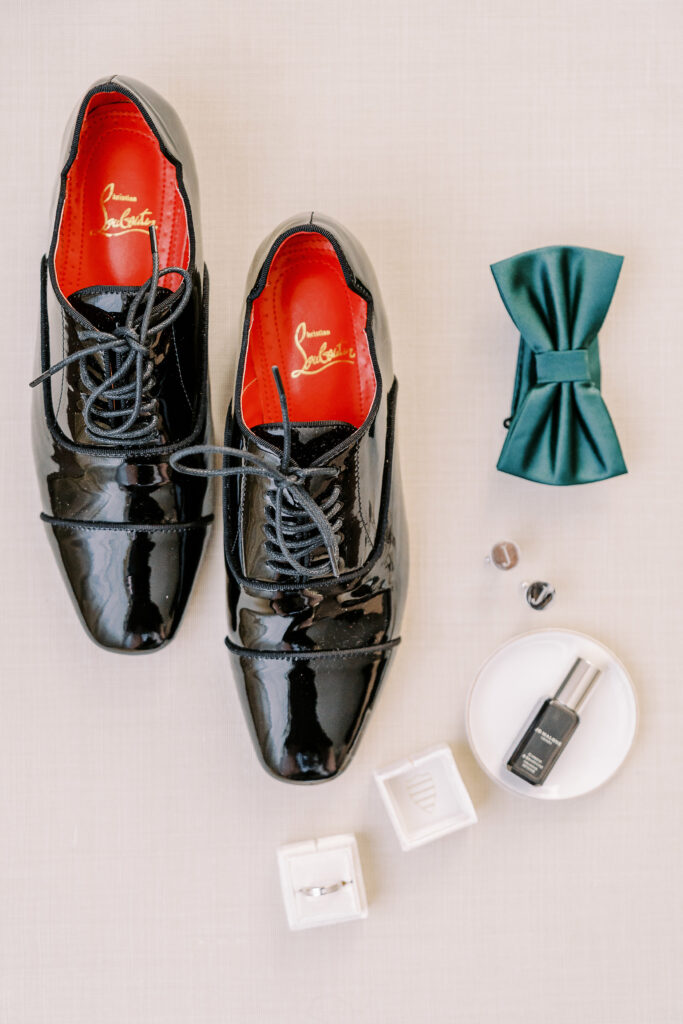 a wedding detail flat lay featuring louboutin shoes for men for a Downtown Sacramento Vizcaya Wedding