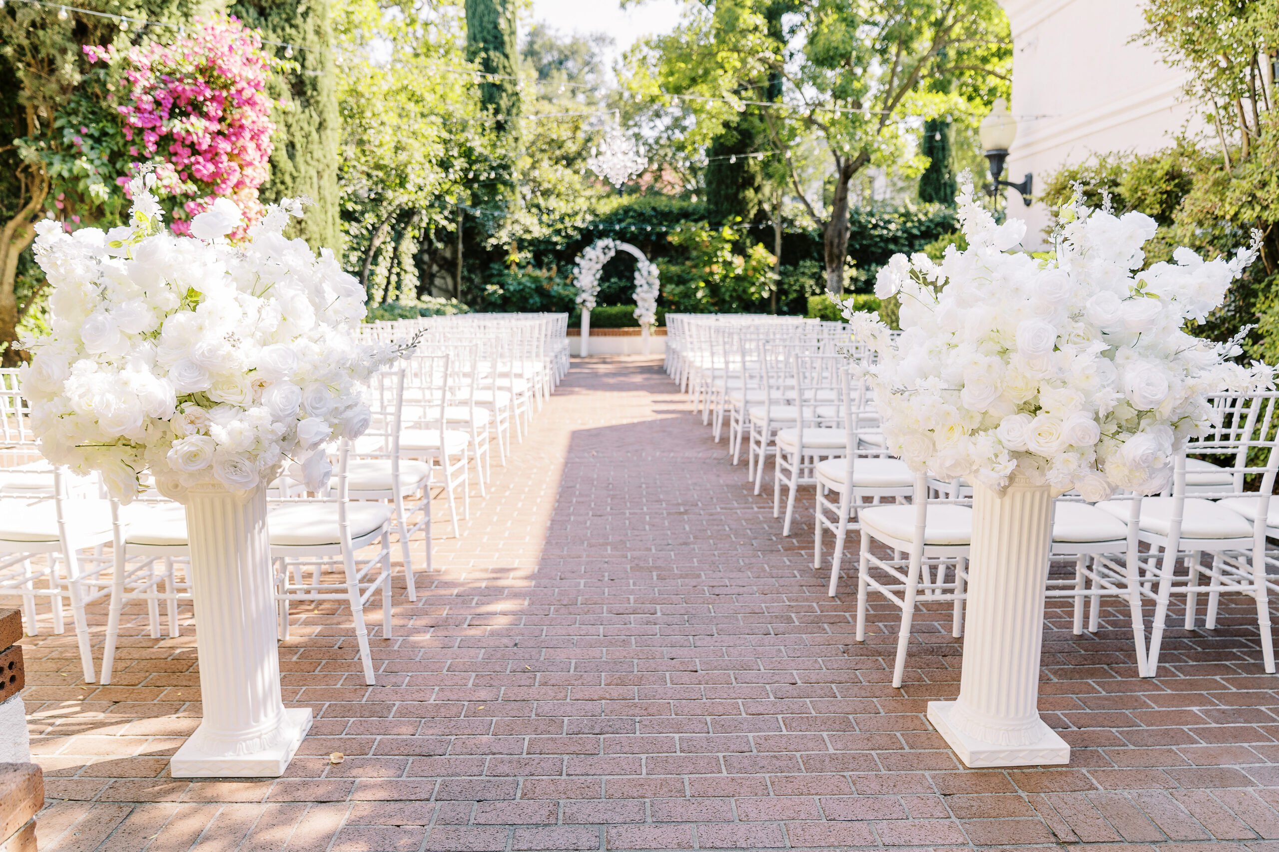 a ceremony set up featuring all white florals for a Downtown Sacramento Vizcaya Wedding