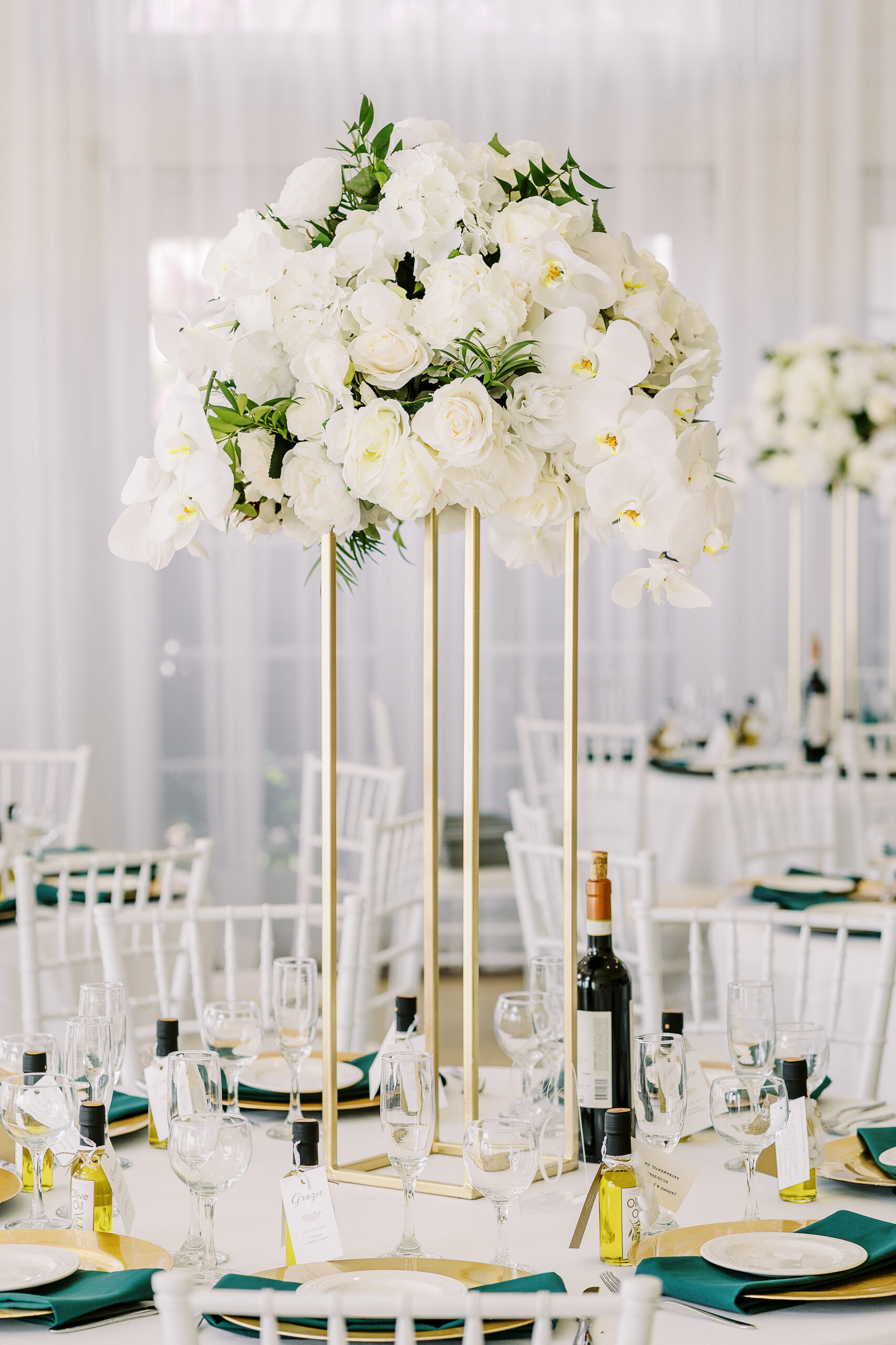 a reception set up for a Downtown Sacramento Vizcaya Wedding featuring tall centerpieces of white florals