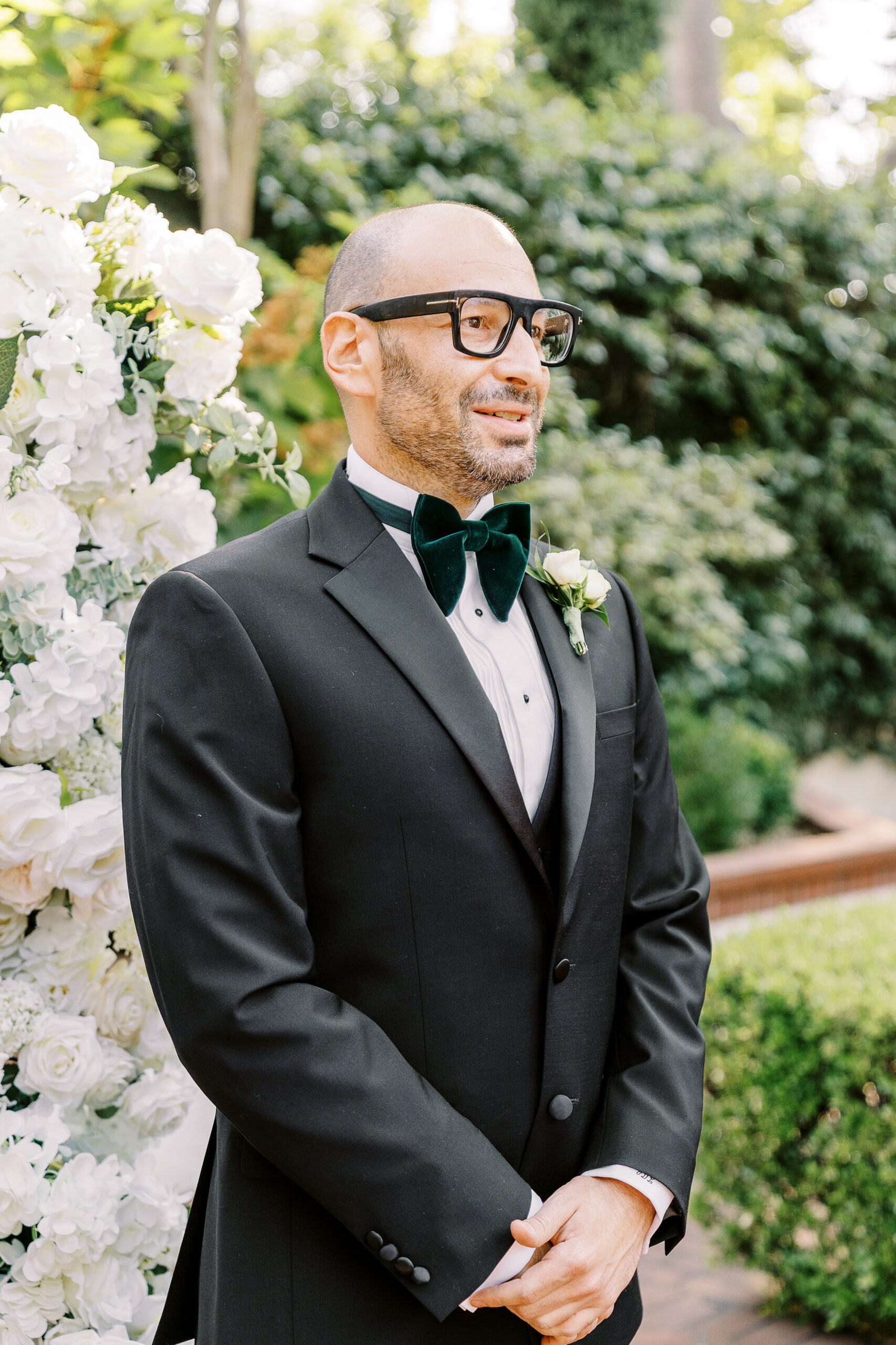 a groom watches his soon to be spouse walk down the aisle escorted by his mother at a Downtown Sacramento Vizcaya Wedding 