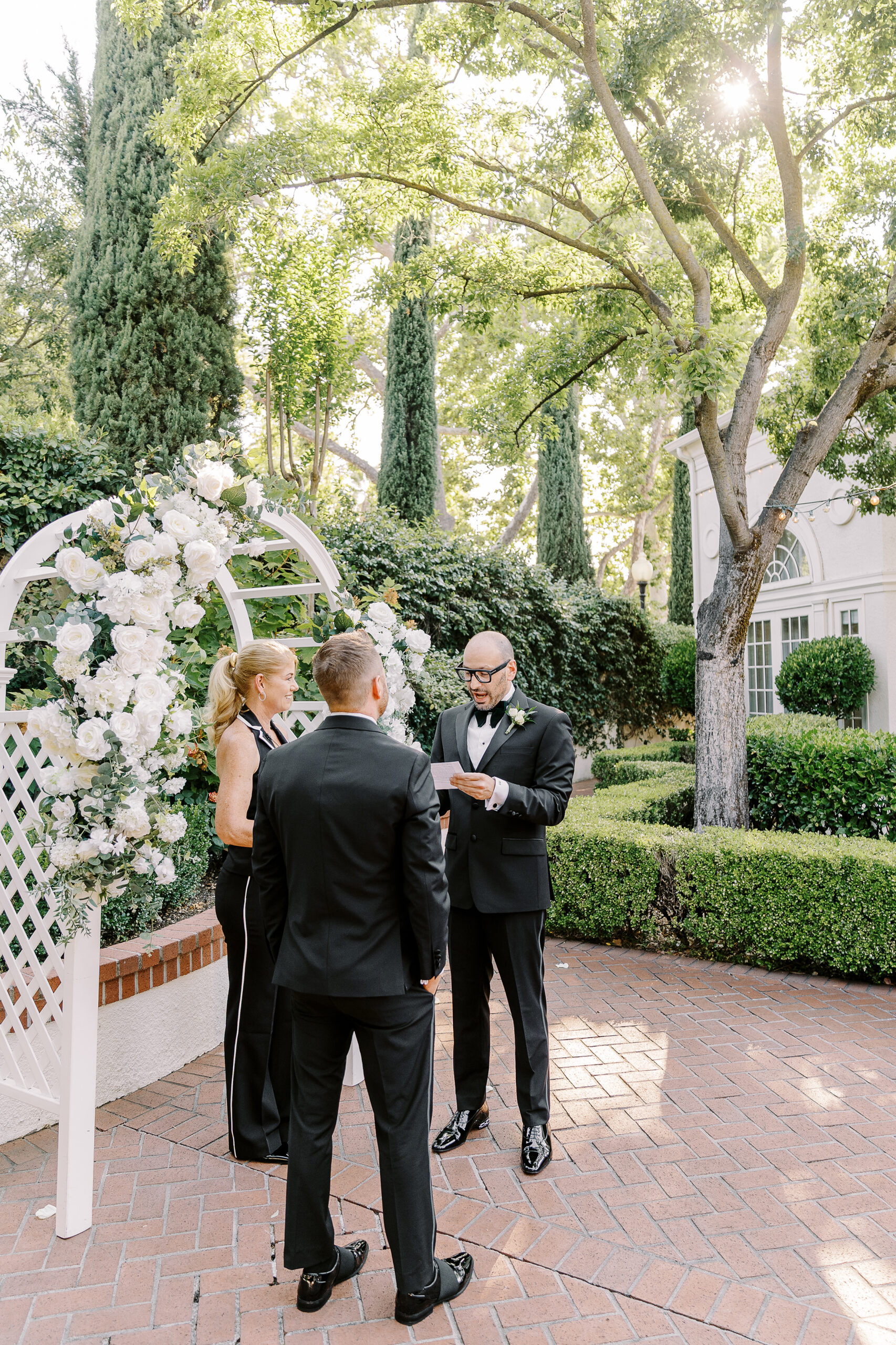 two grooms read their vows to each other during their wedding ceremony at their Downtown Sacramento Vizcaya Wedding 