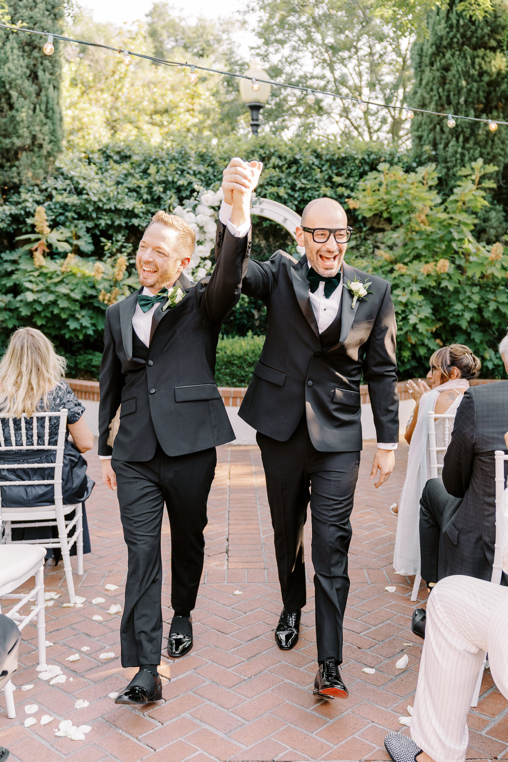 two grooms celebrate after their wedding ceremony at their Downtown Sacramento Vizcaya Wedding 