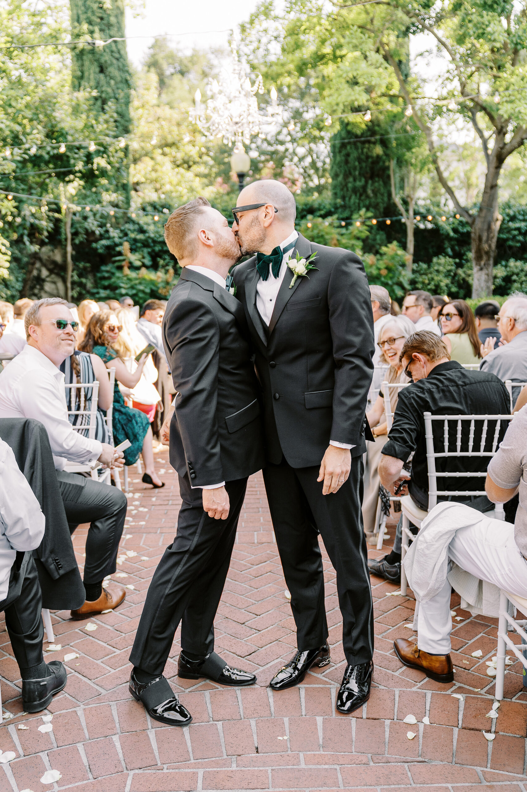 two grooms kiss in the aisle after their wedding ceremony at their Downtown Sacramento Vizcaya Wedding 