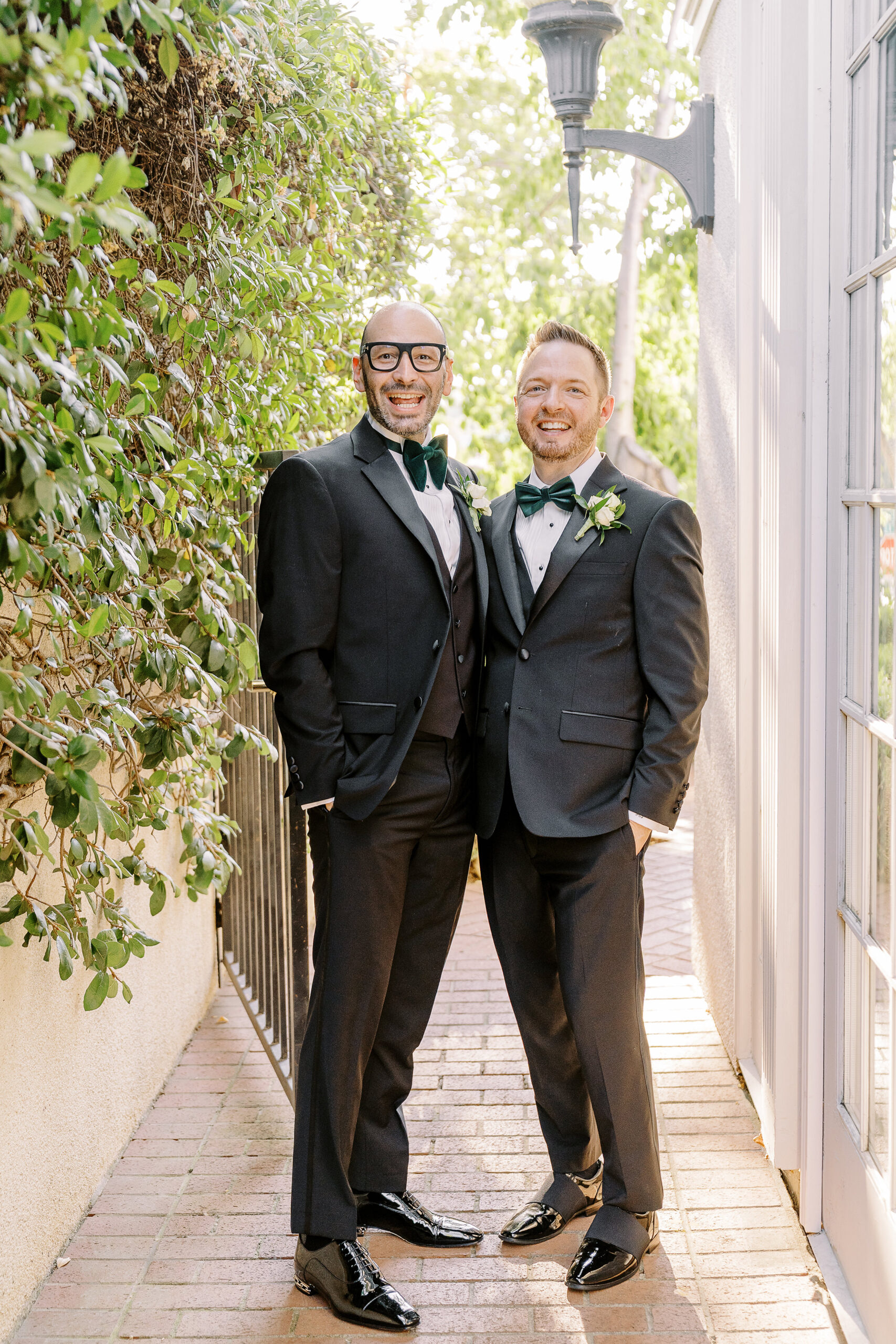 two grooms pose for a portrait and laugh at their Downtown Sacramento Vizcaya Wedding 