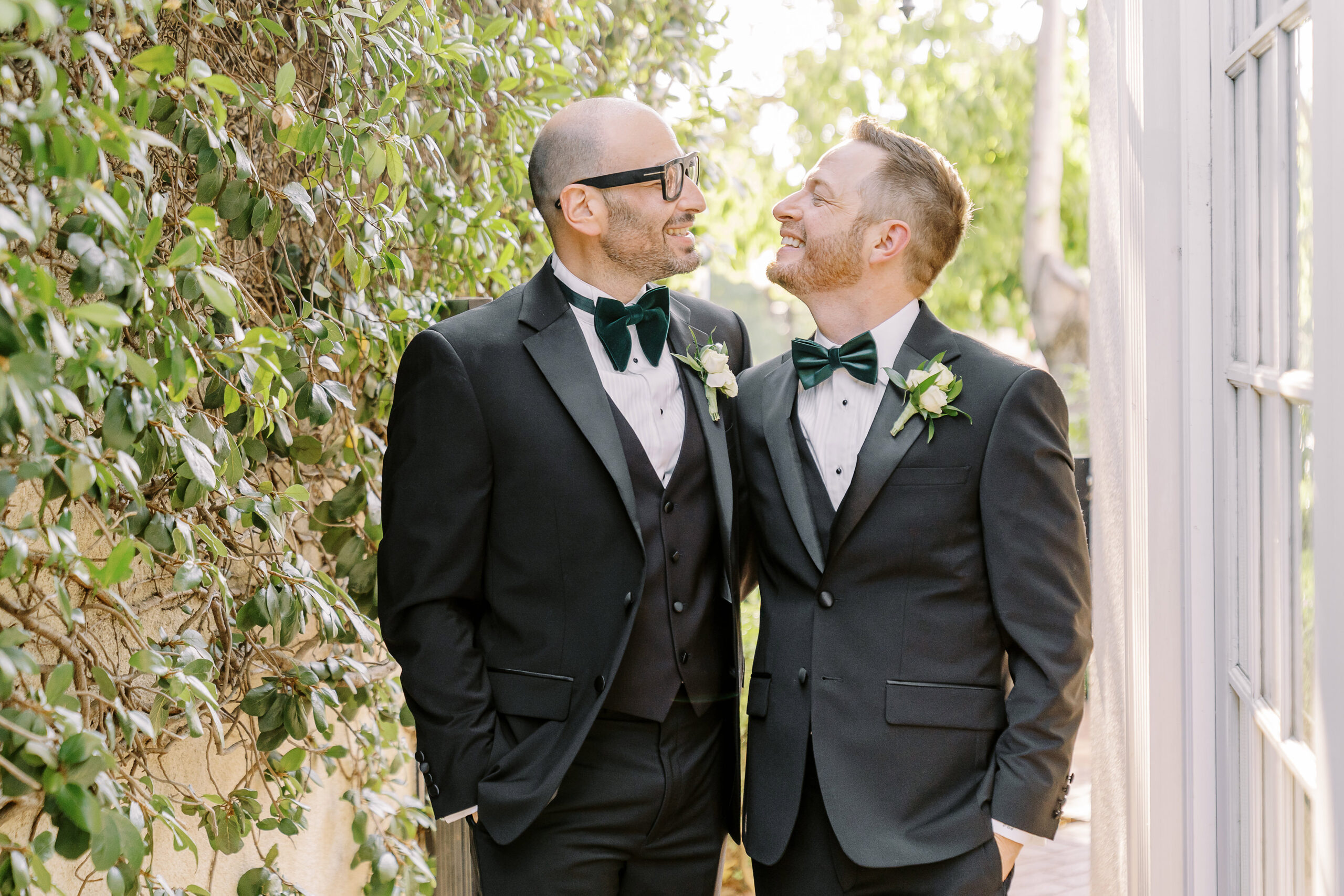two grooms share a laugh at their Downtown Sacramento Vizcaya Wedding 