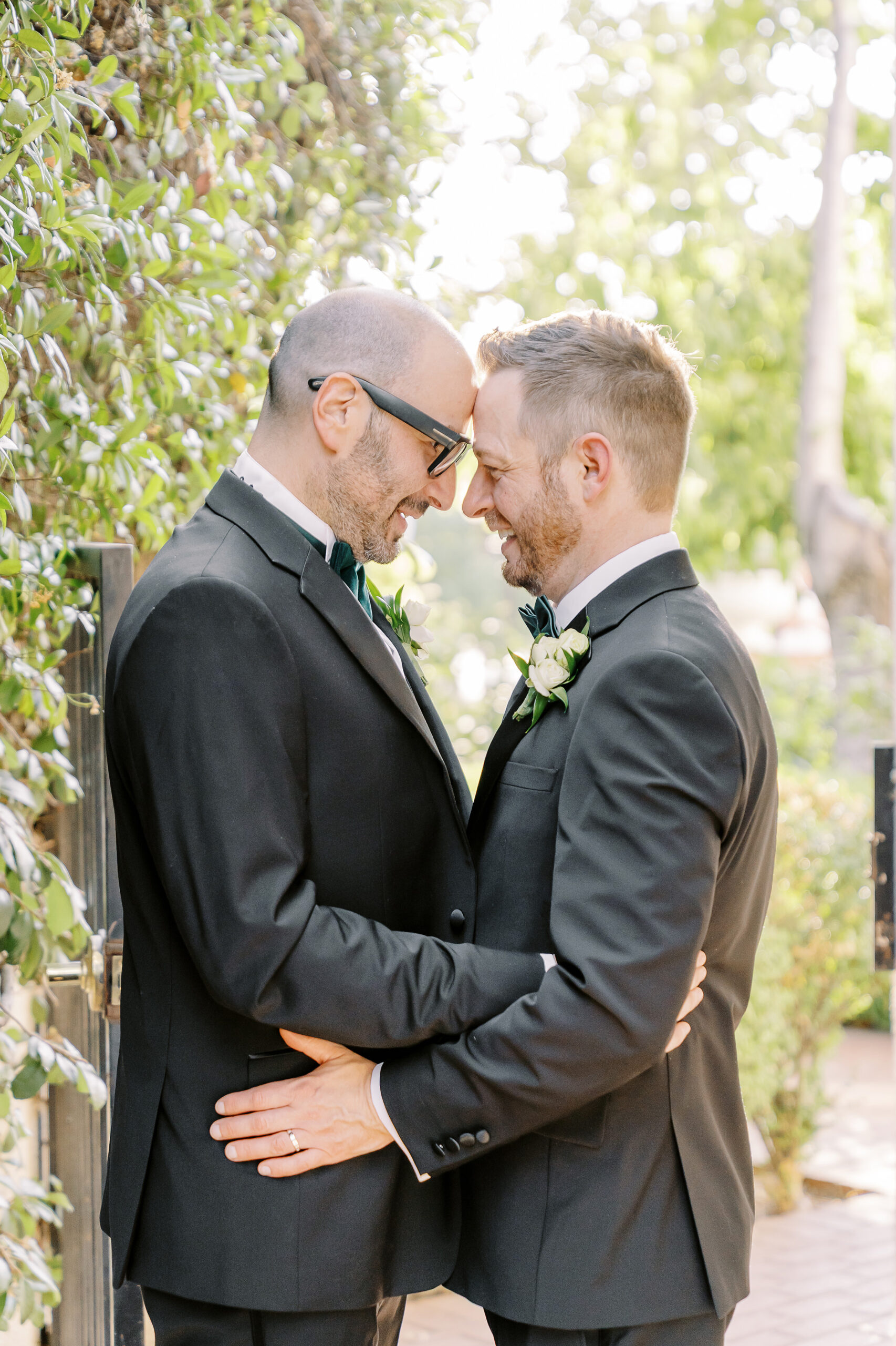 two grooms rest their foreheads together at their Downtown Sacramento Vizcaya Wedding 