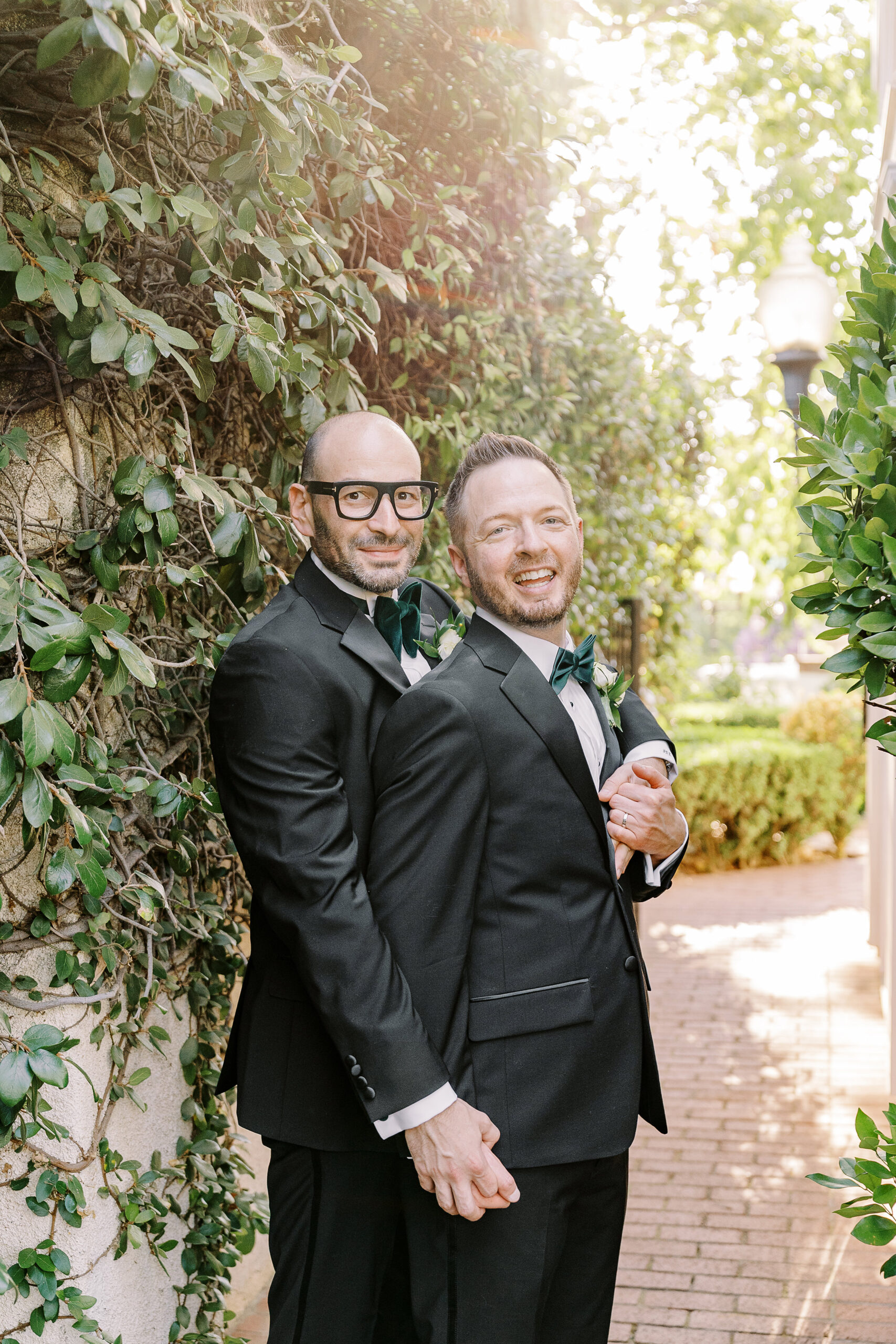two grooms embrace each other at their Downtown Sacramento Vizcaya Wedding 