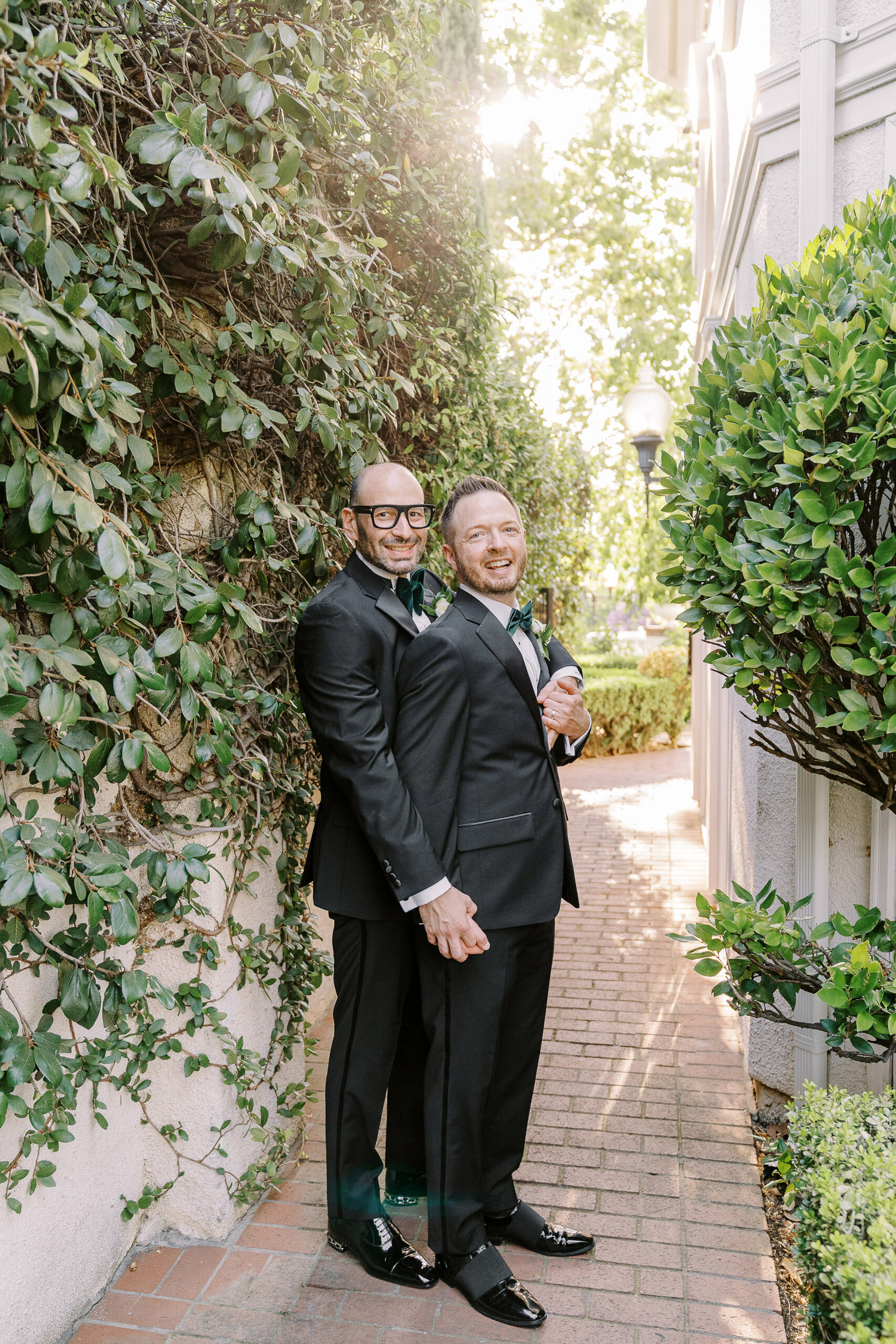 two grooms embrace each other at their Downtown Sacramento Vizcaya Wedding 
