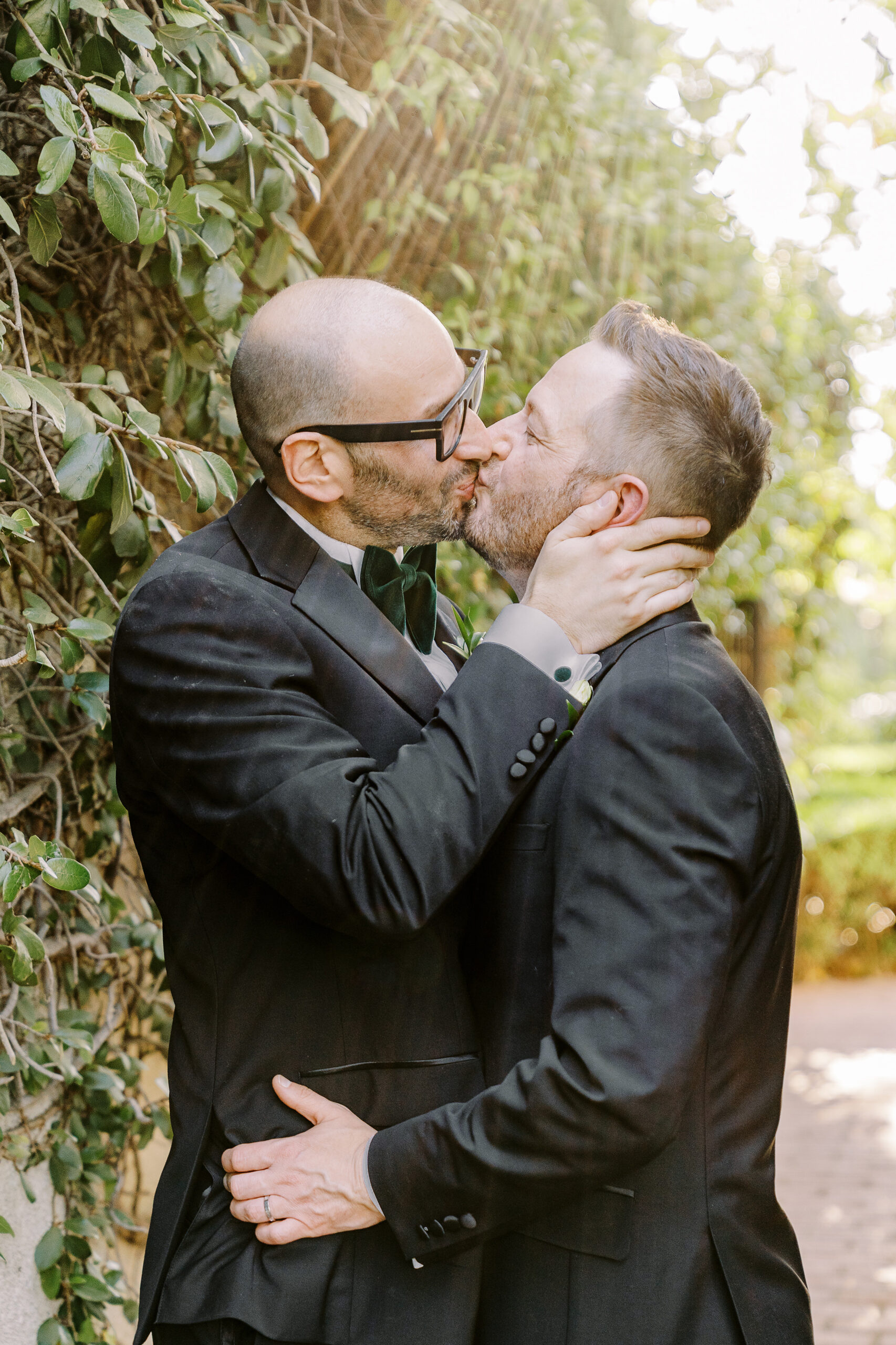 two grooms share a kiss at their Downtown Sacramento Vizcaya Wedding 