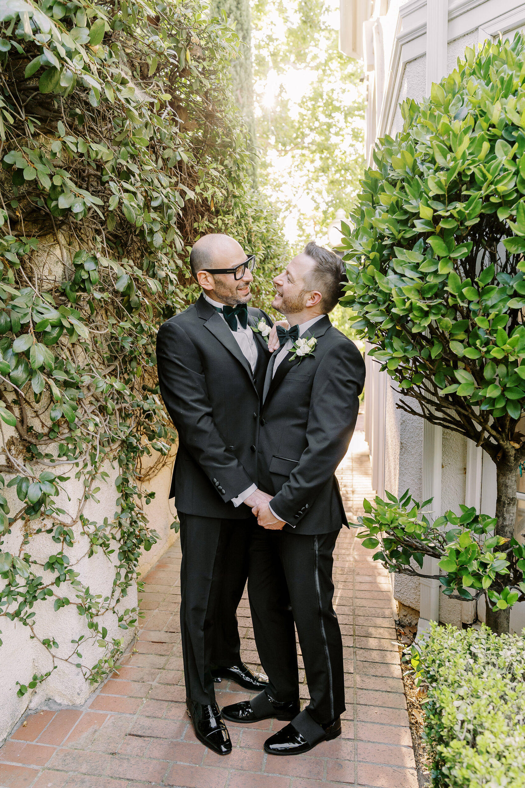 two grooms embrace each other and hold hands at their Downtown Sacramento Vizcaya Wedding 