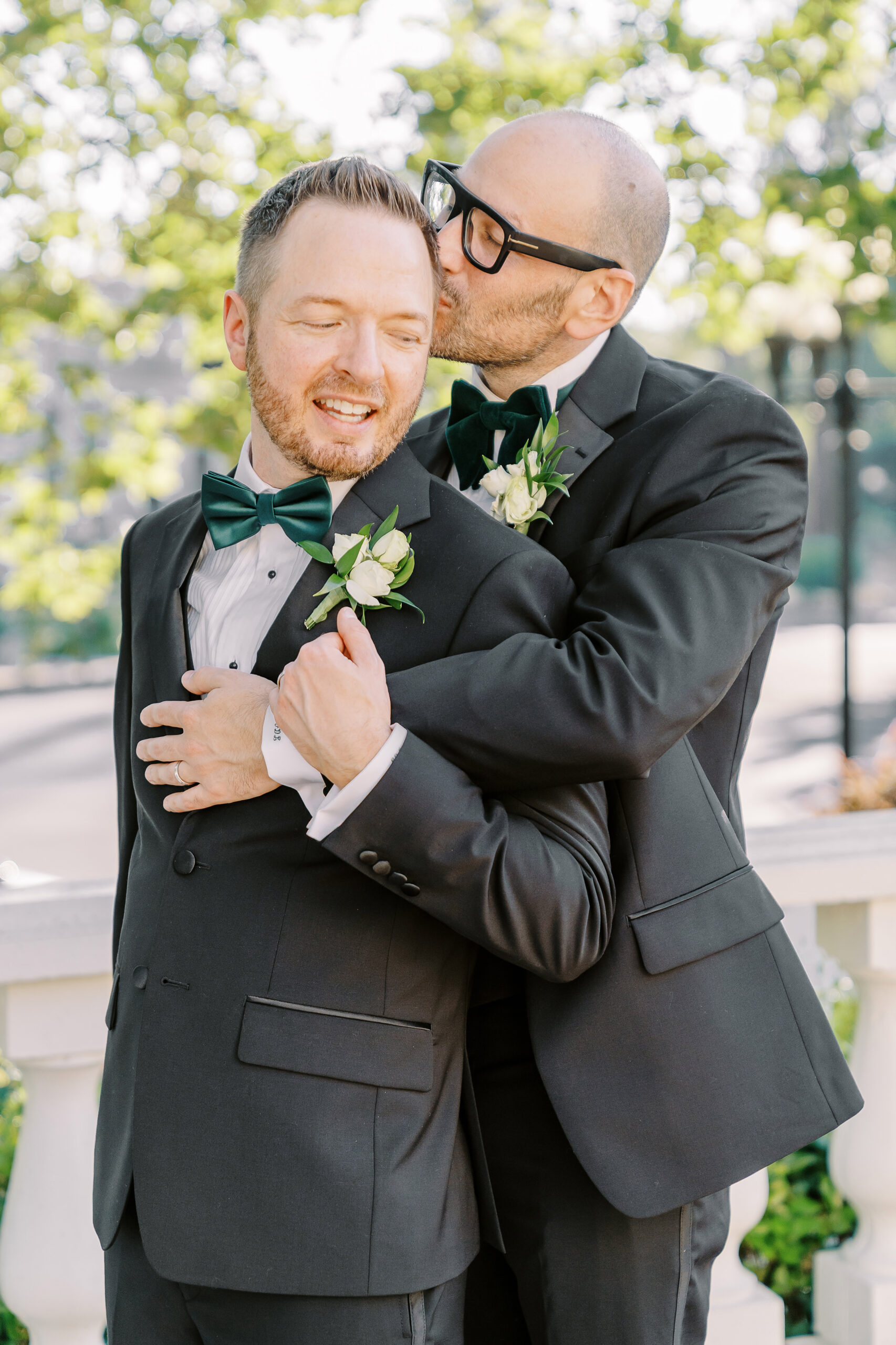 two grooms embrace each other at their Downtown Sacramento Vizcaya Wedding 