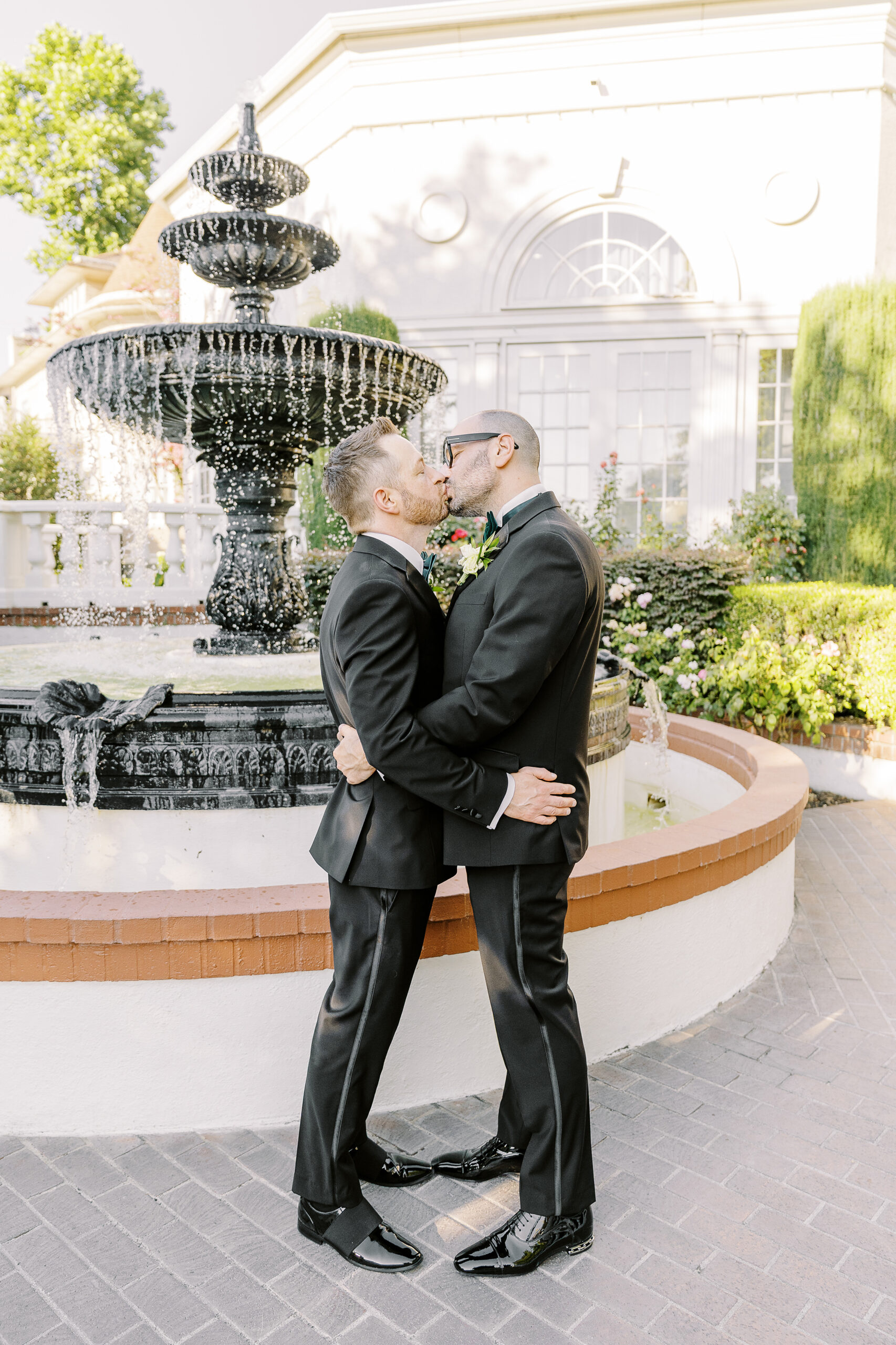 two grooms embrace each other at their Downtown Sacramento Vizcaya Wedding 