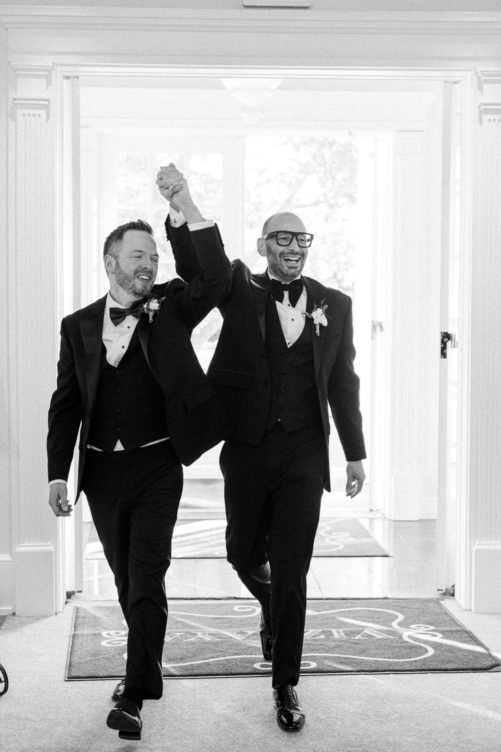 two grooms enter their reception at their Downtown Sacramento Vizcaya Wedding 