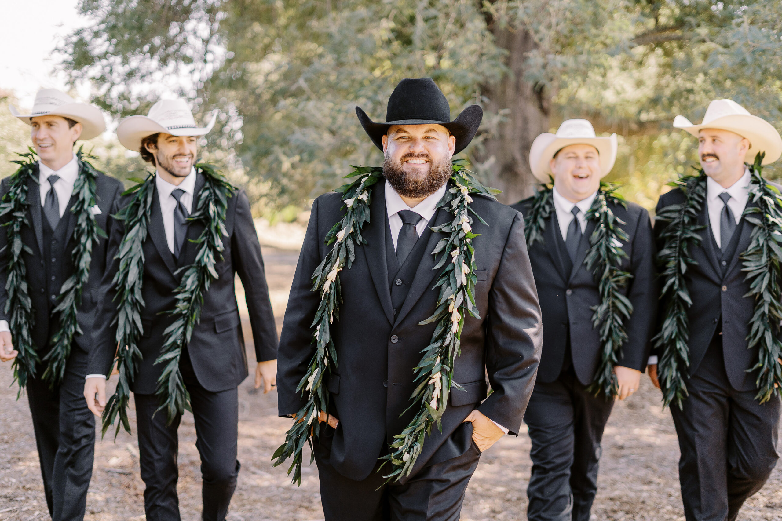 a large 18 person wedding party featuring black suits and white cowboy hats for the gentlemen for a sonoma winery wedding.