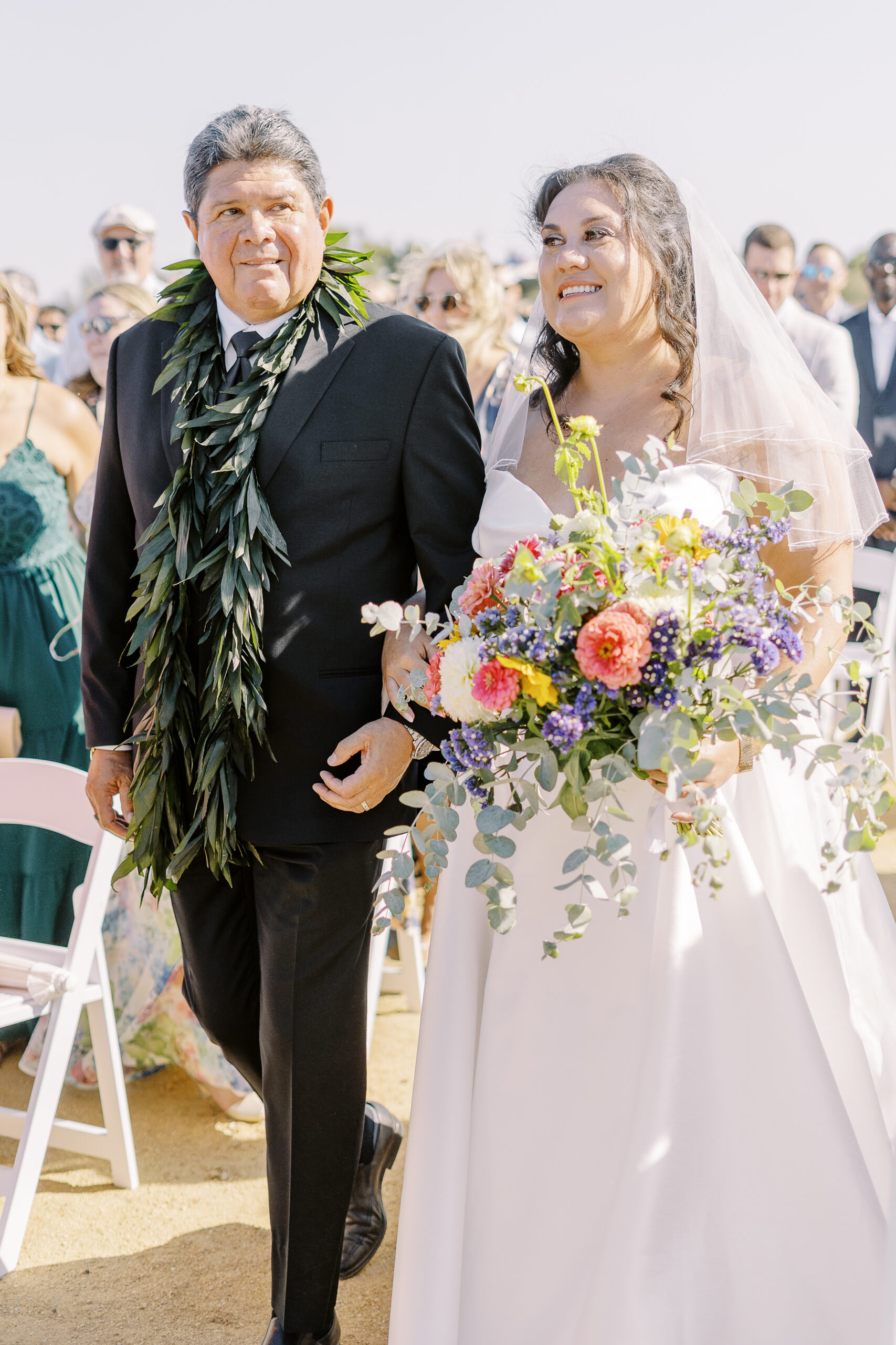 a bride walks down the aisle with her father at her Sonoma winery wedding.