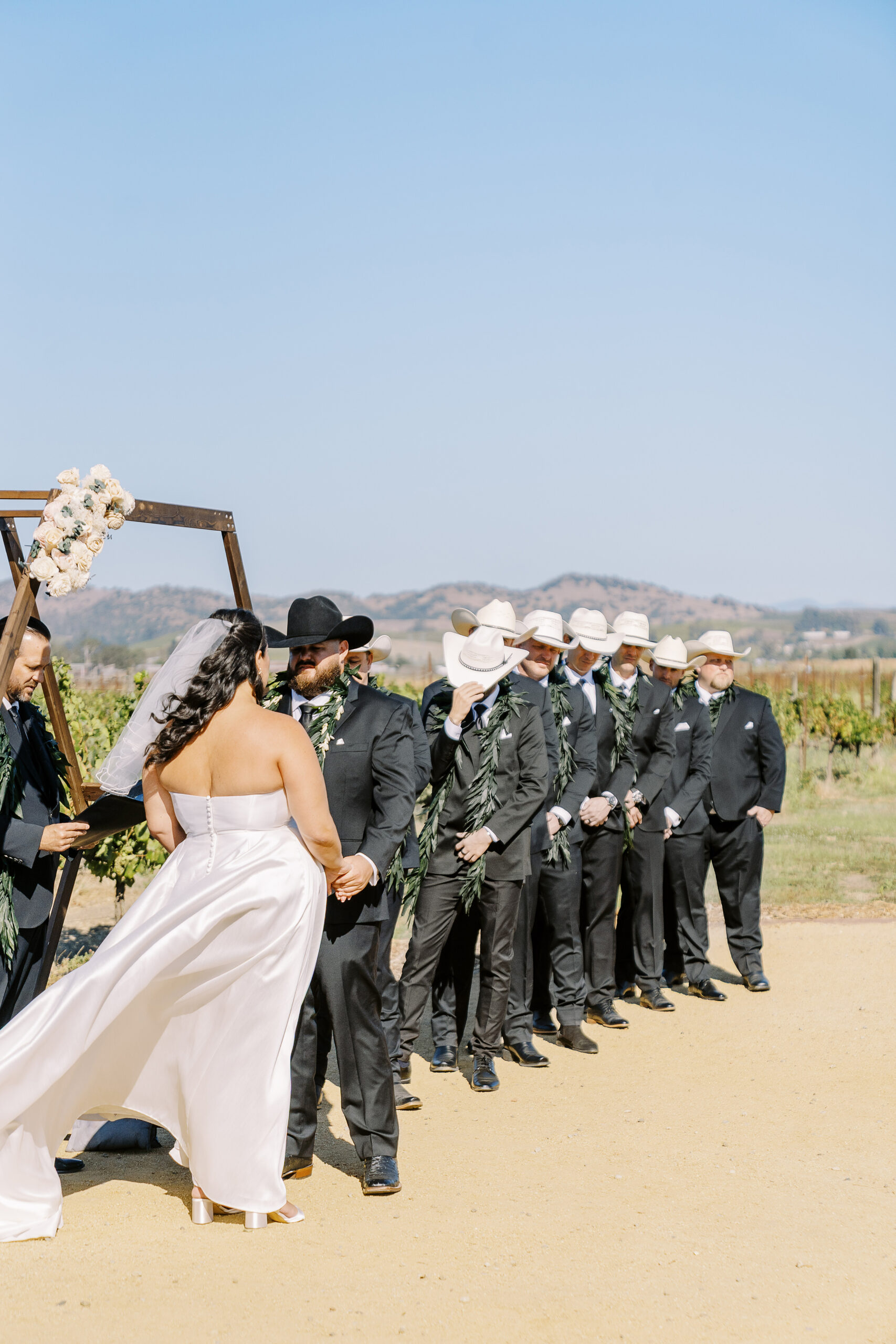 a bride and groom share a laugh during their wedding ceremony during their sonoma winery wedding.