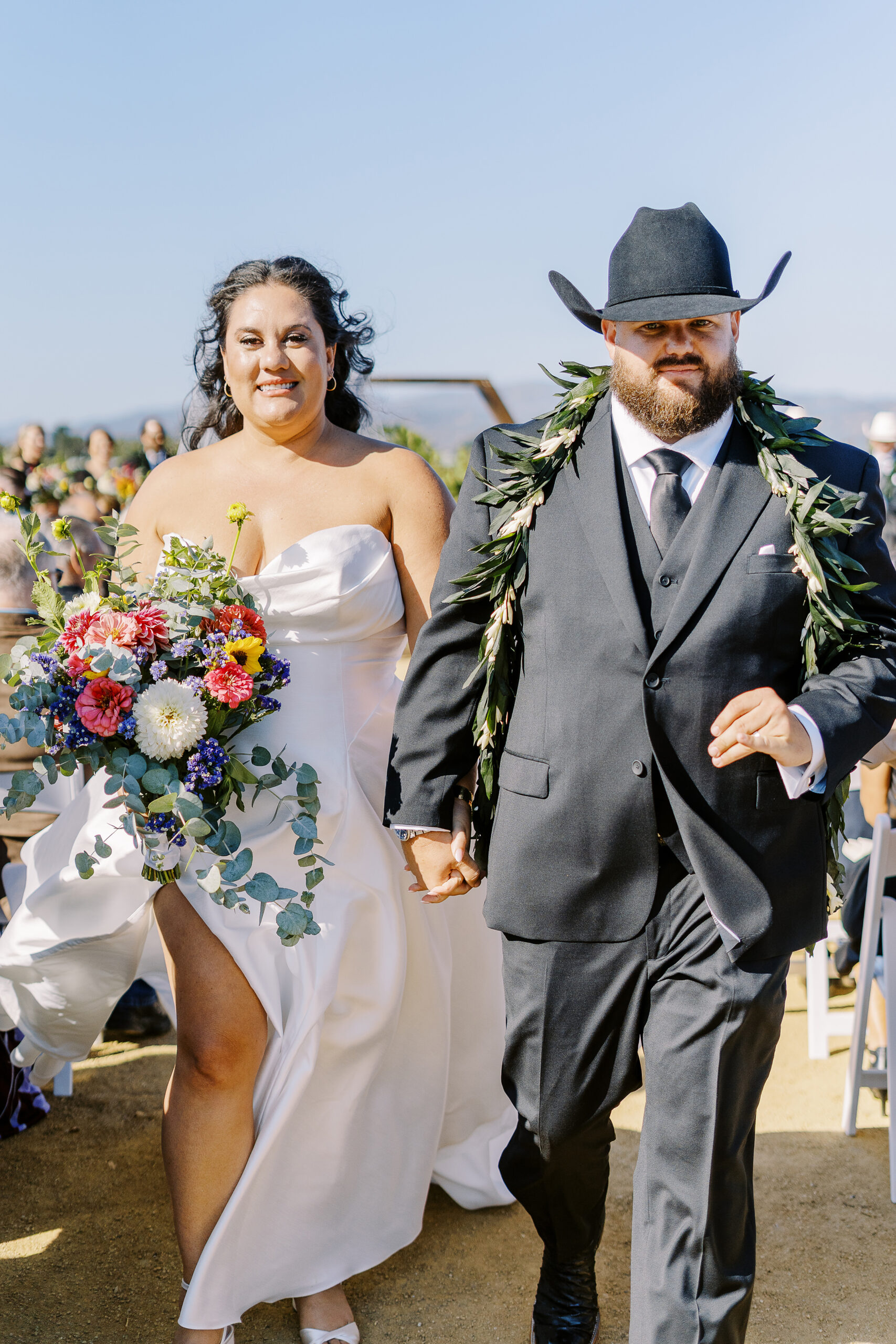 a bride and groom walk down their aisle after their sonoma winery wedding ceremony.