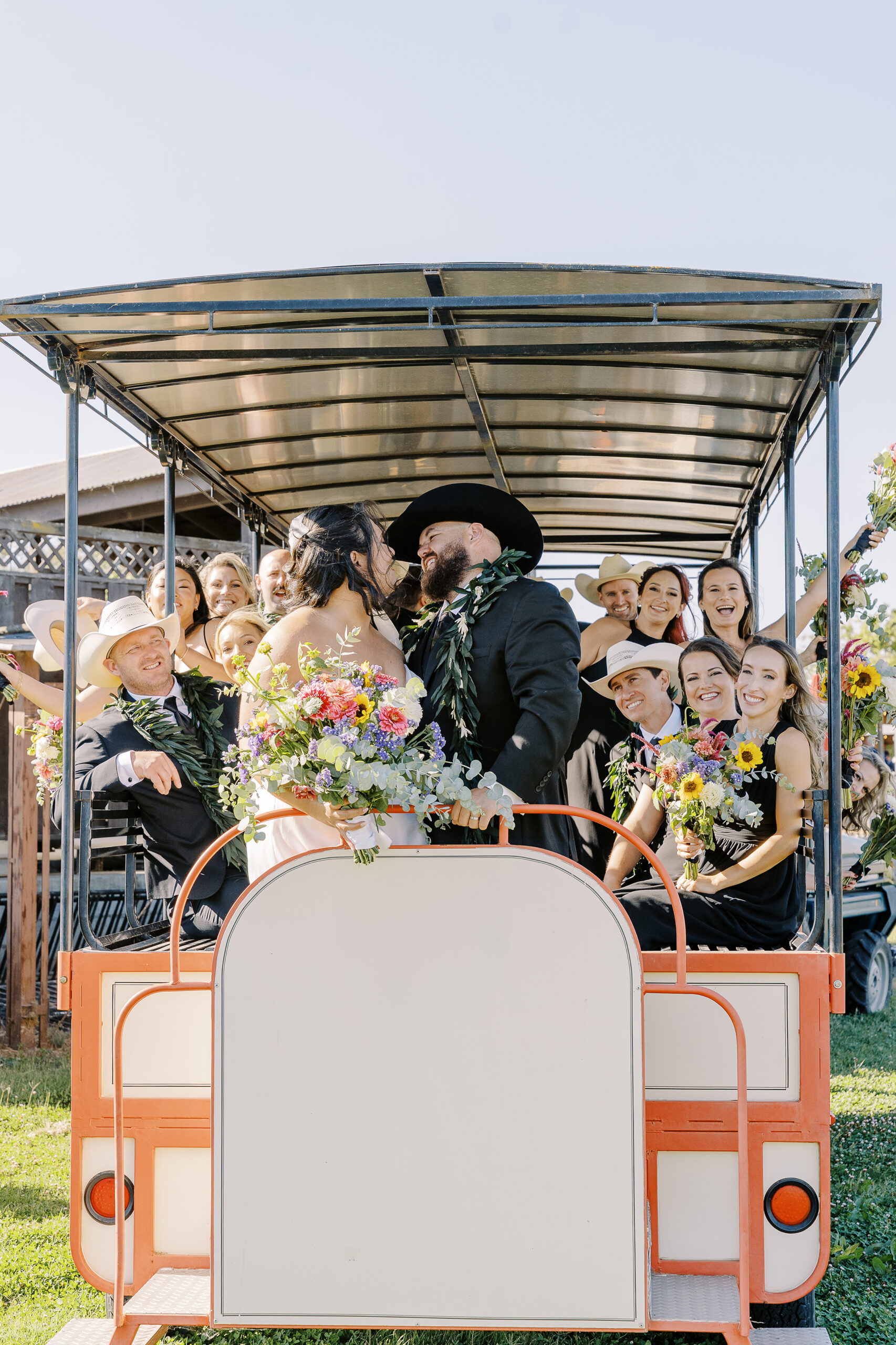 a wedding party cheer for the newly wed bride and groom