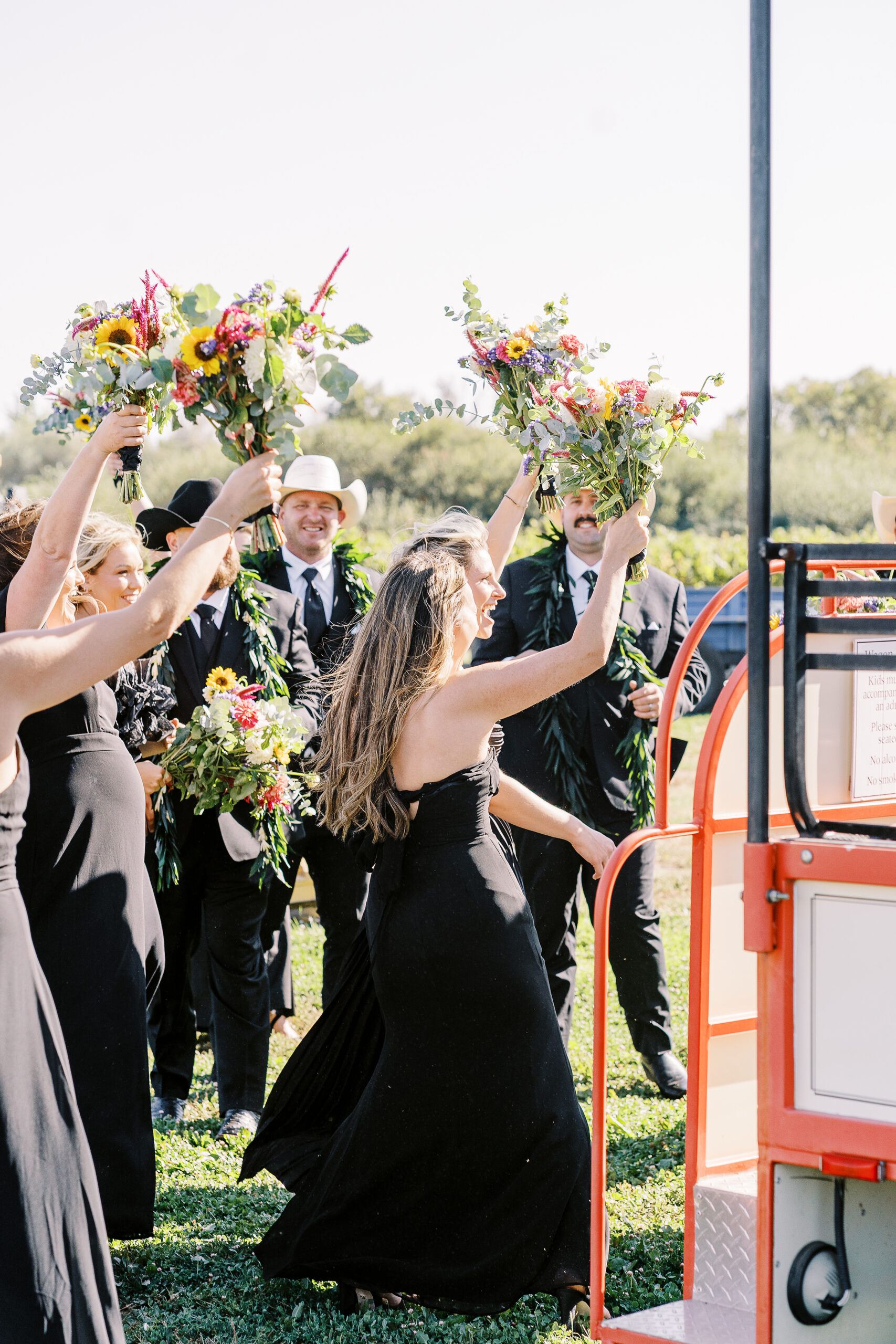 a wedding party cheer for the newly wed bride and groom