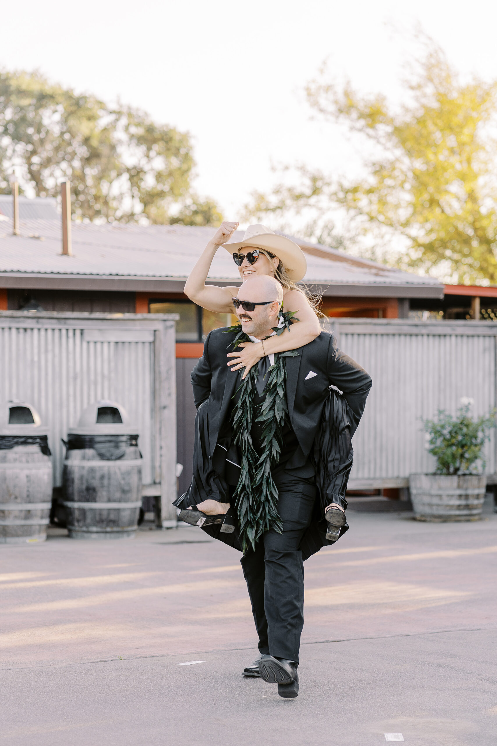 a rowdy wedding party makes their entrances to a reception at a sonoma winery wedding.