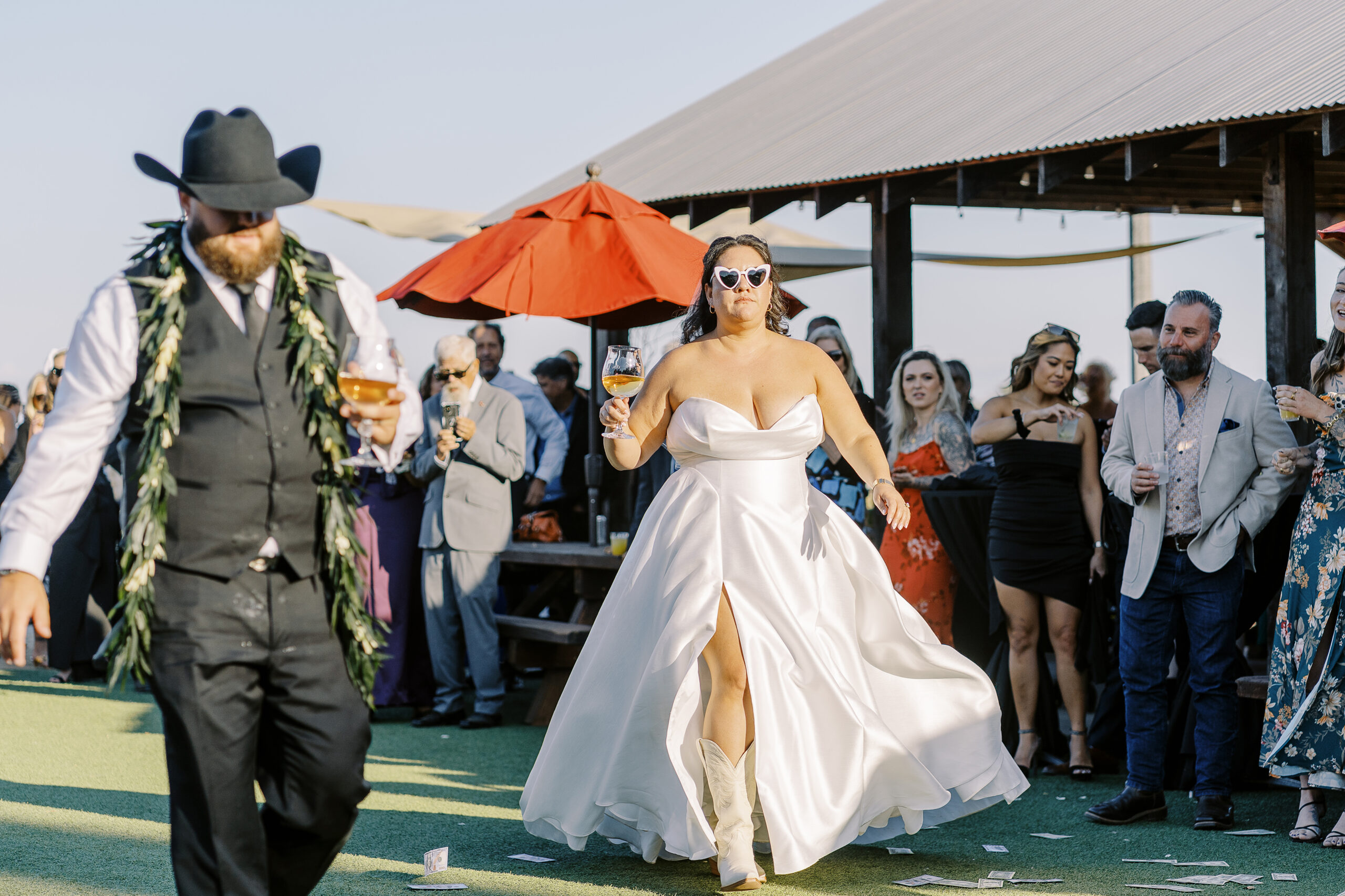 a bride and groom greet guests at their reception. 