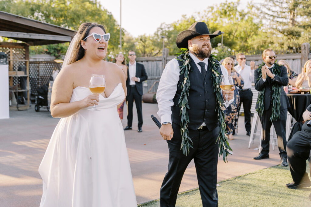 a bride and groom greet guests at their reception. 