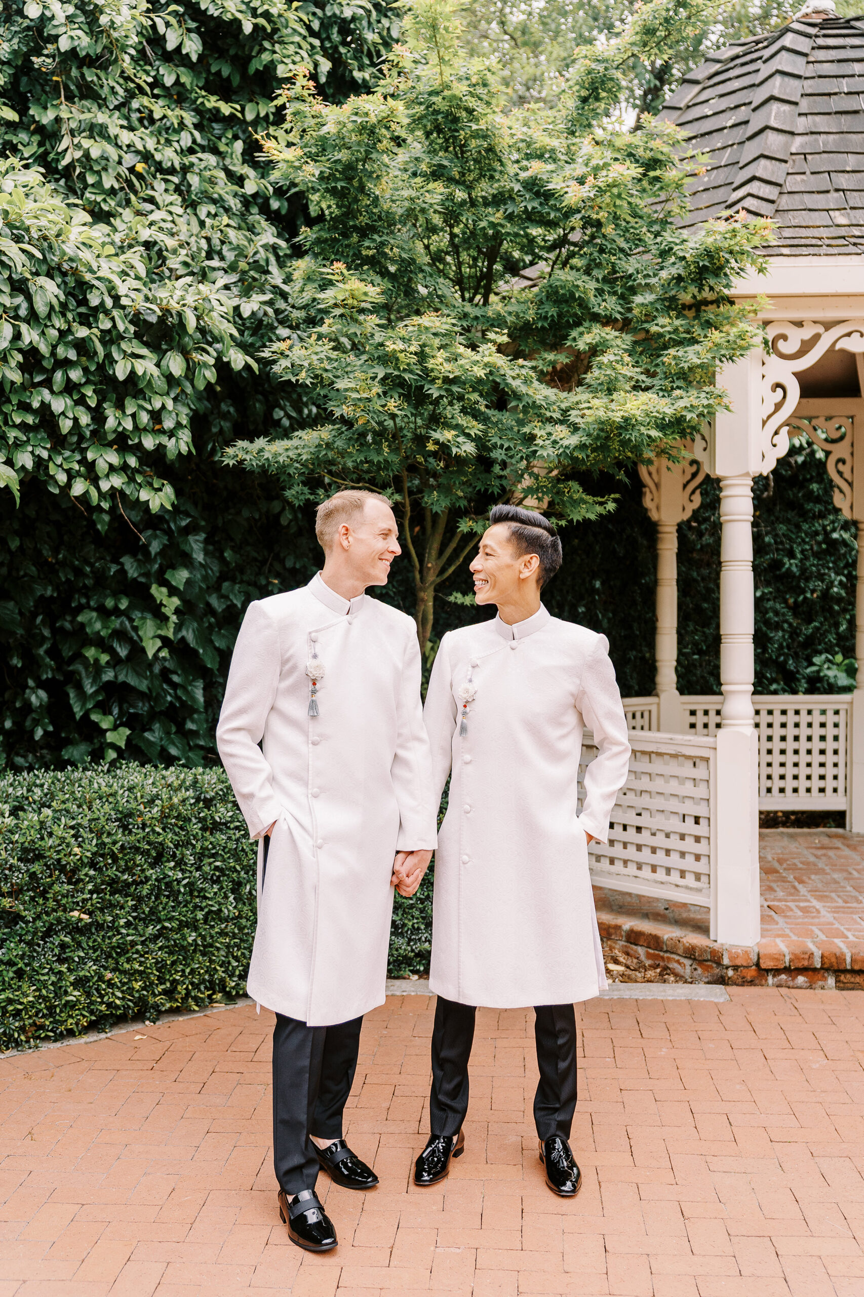two grooms smile at each other while wearing their ao dais for their Vizcaya Sacramento Wedding