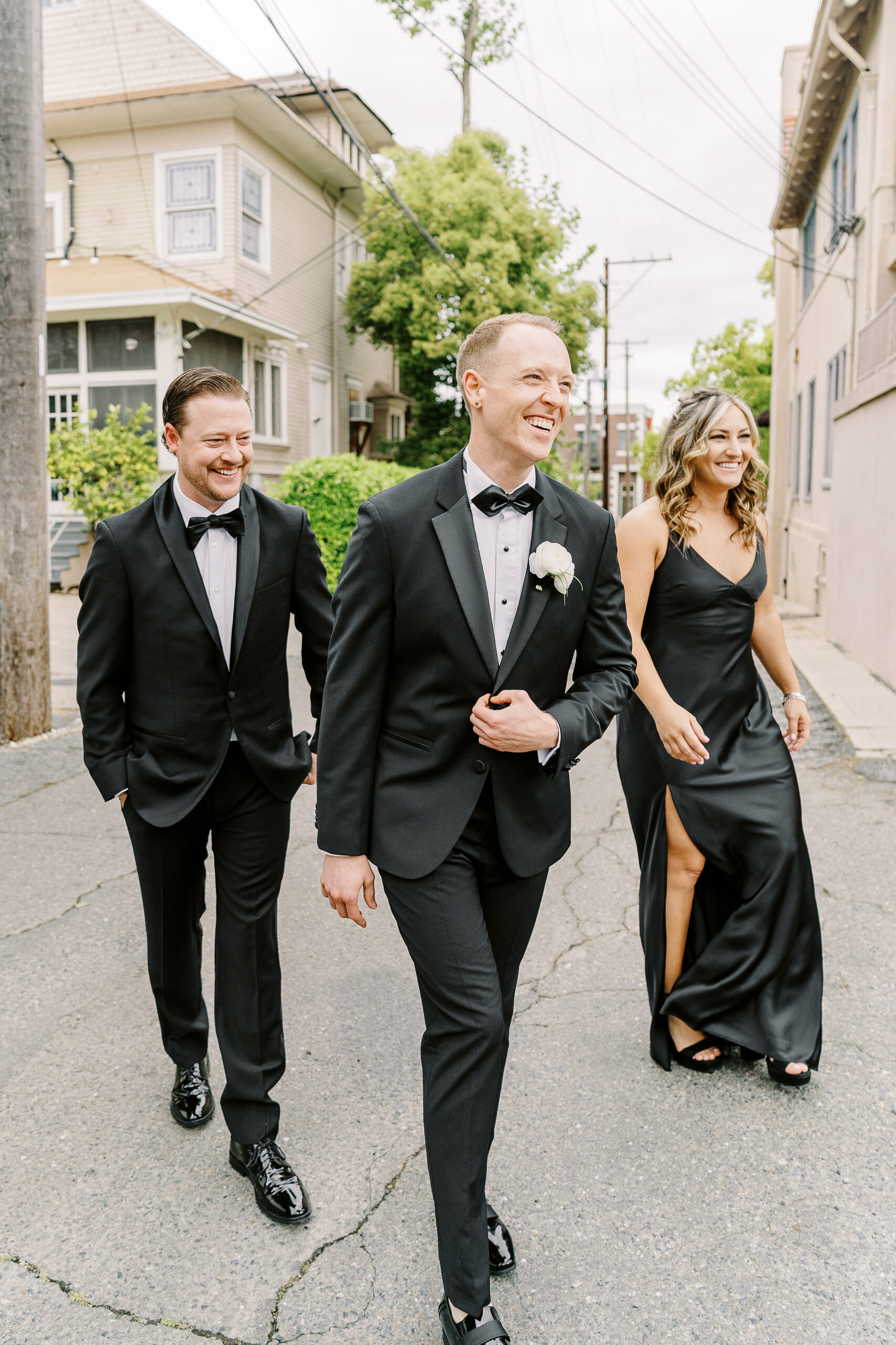 a groom walks with his siblings at the vizcaya sacramento wedding venue