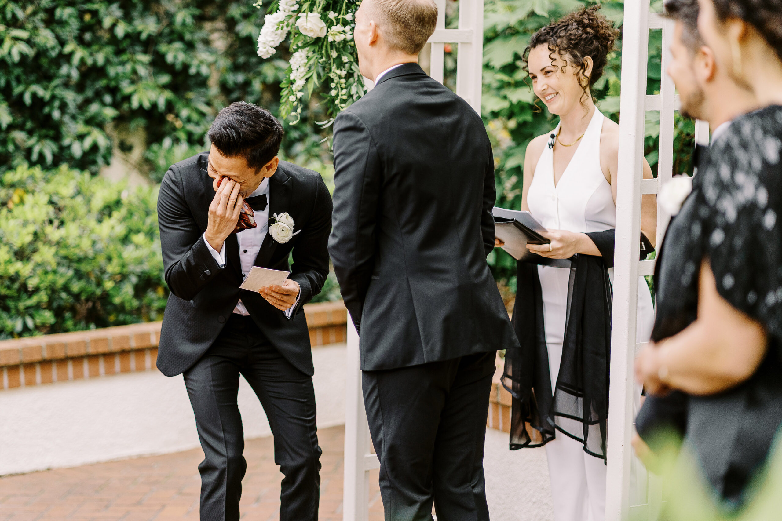 a groom wipes away a tear at a lgbtq vizcaya sacramento wedding ceremony