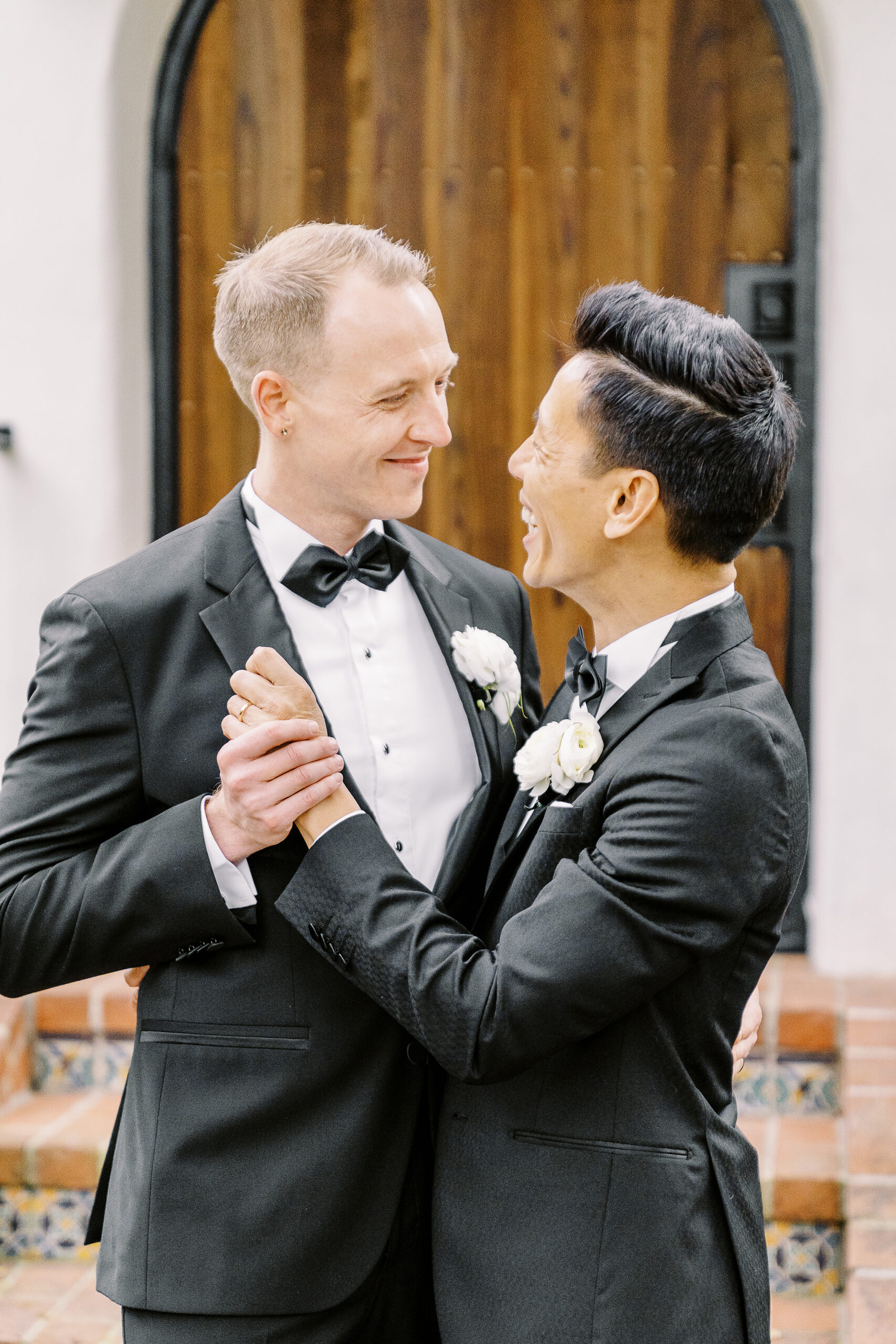two groom embrace each other at their vizcaya sacramento wedding