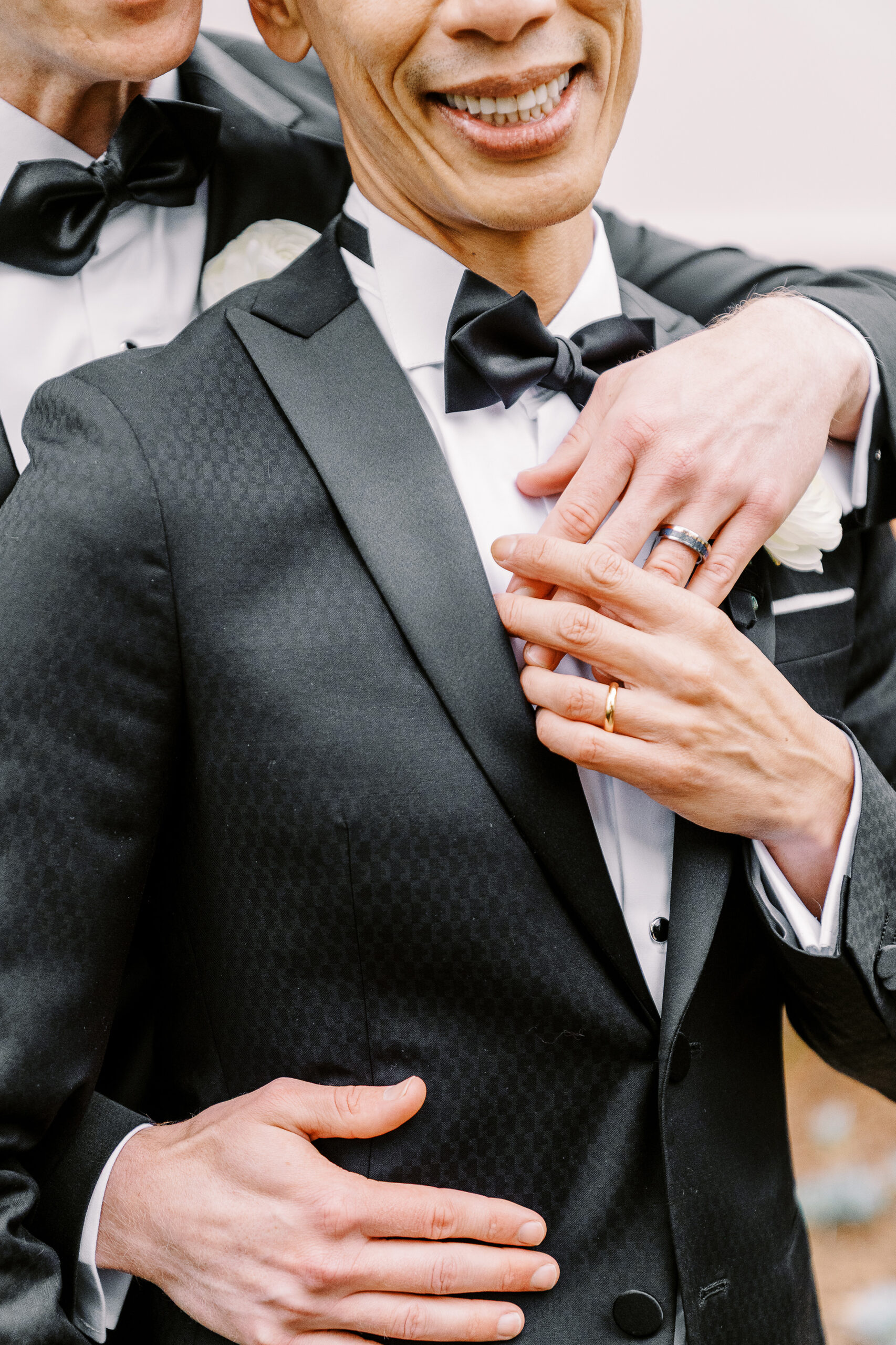 a close up photo of groom's hands showing off their wedding rings at their vizcaya sacramento wedding