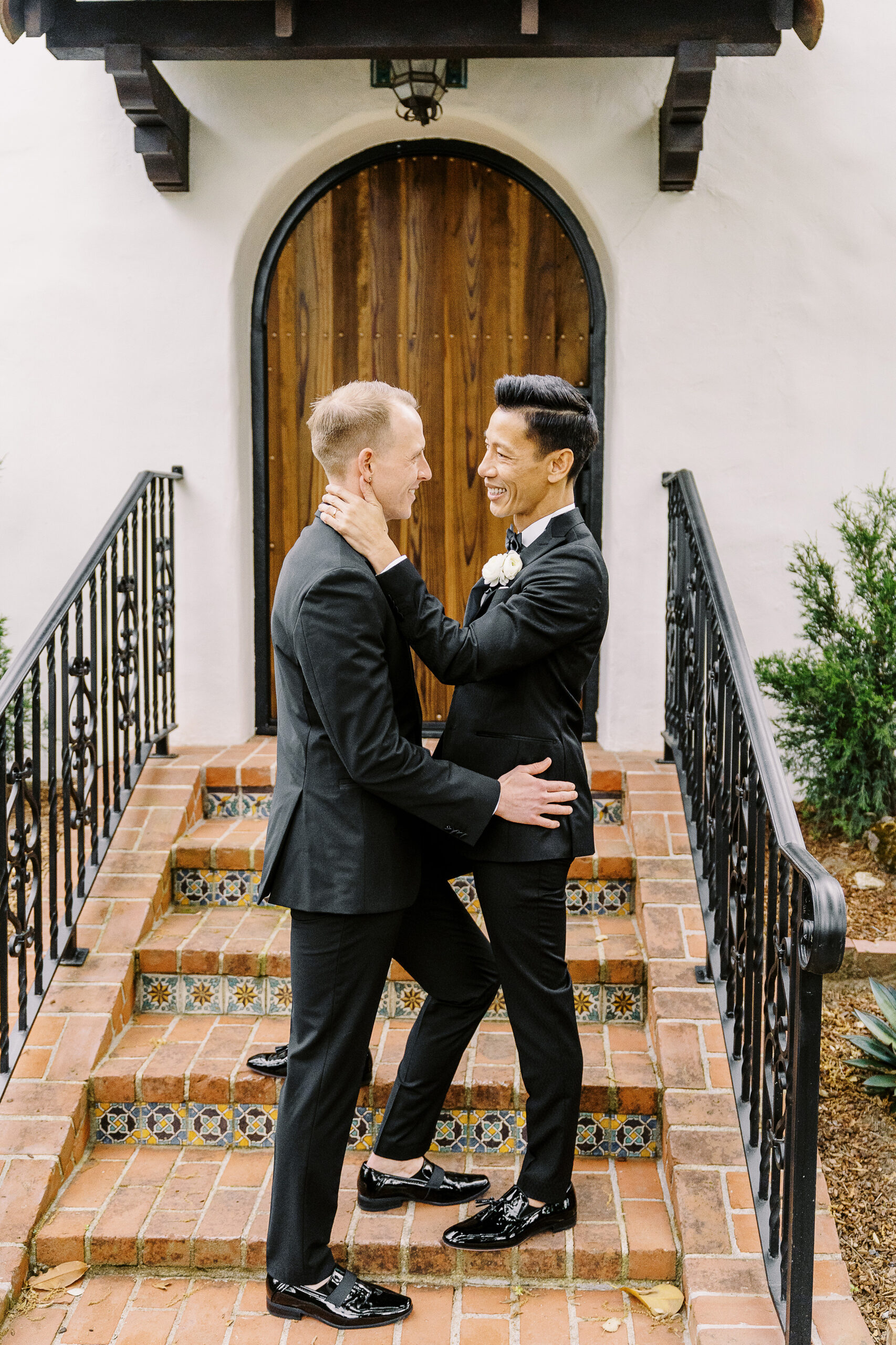 two grooms embrace for a kiss at their vizcaya sacramento wedding