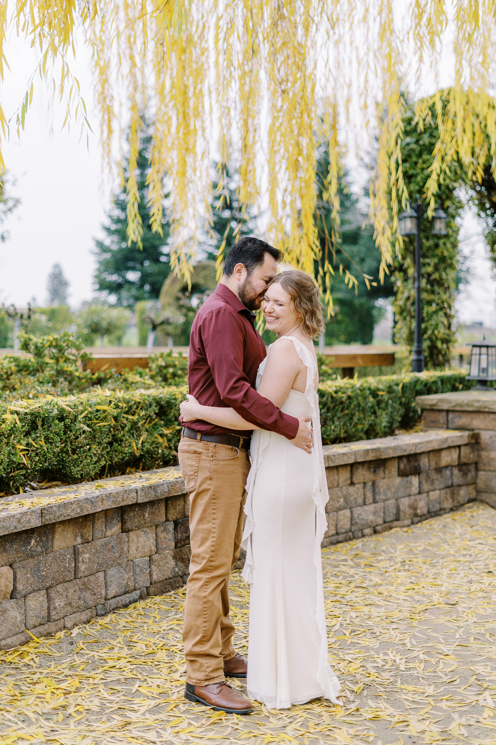 a couple shares a snuggle during their sacramento wolfe heights winery engagement photos