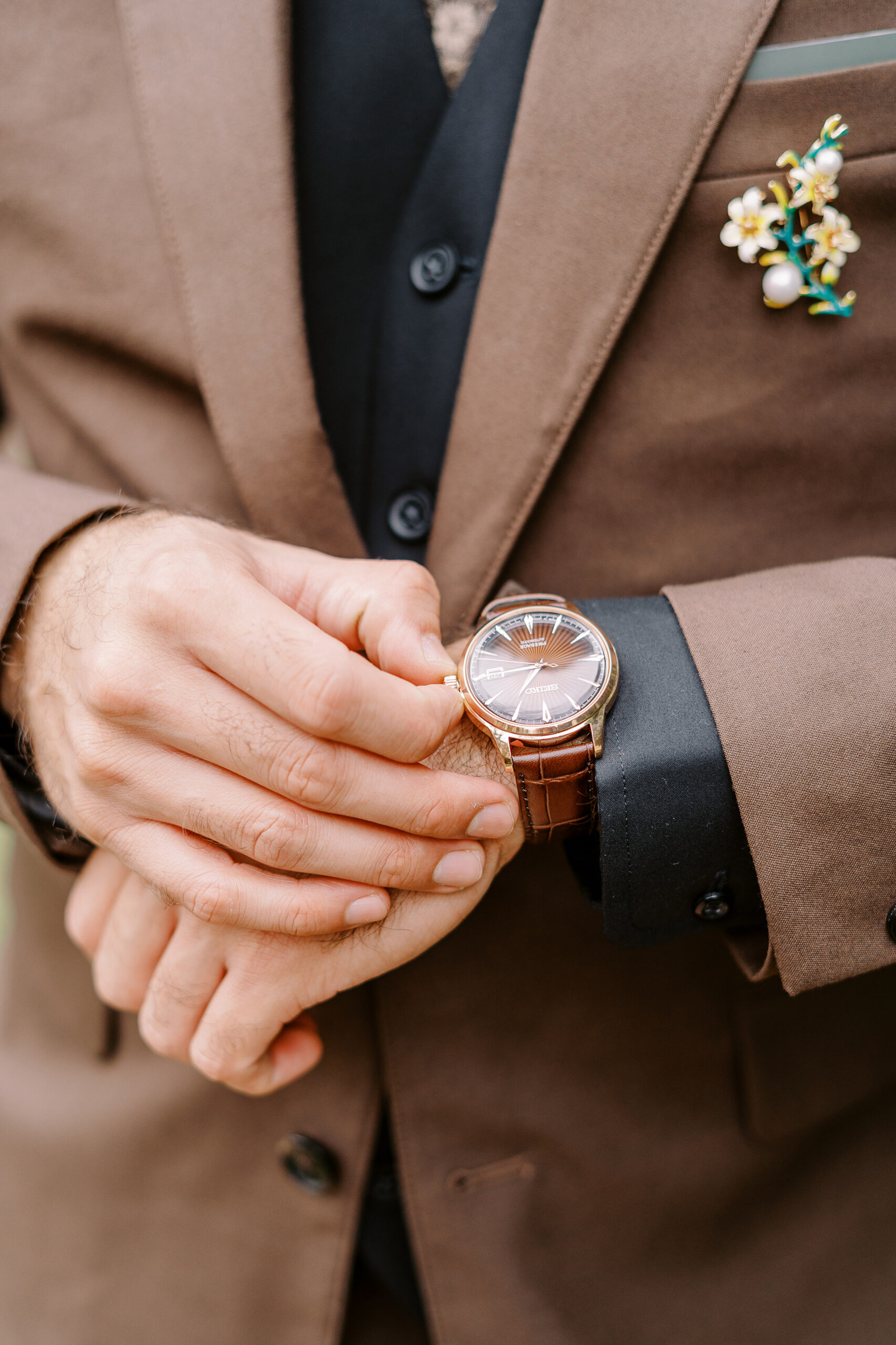 a groom adjust his watch at Vizcaya photographed by Sacramento wedding photographers