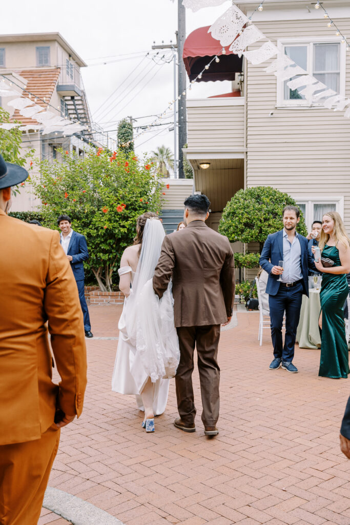 a bride and groom walk into their cocktail hour at Vizcaya photographed by Sacramento wedding photographers