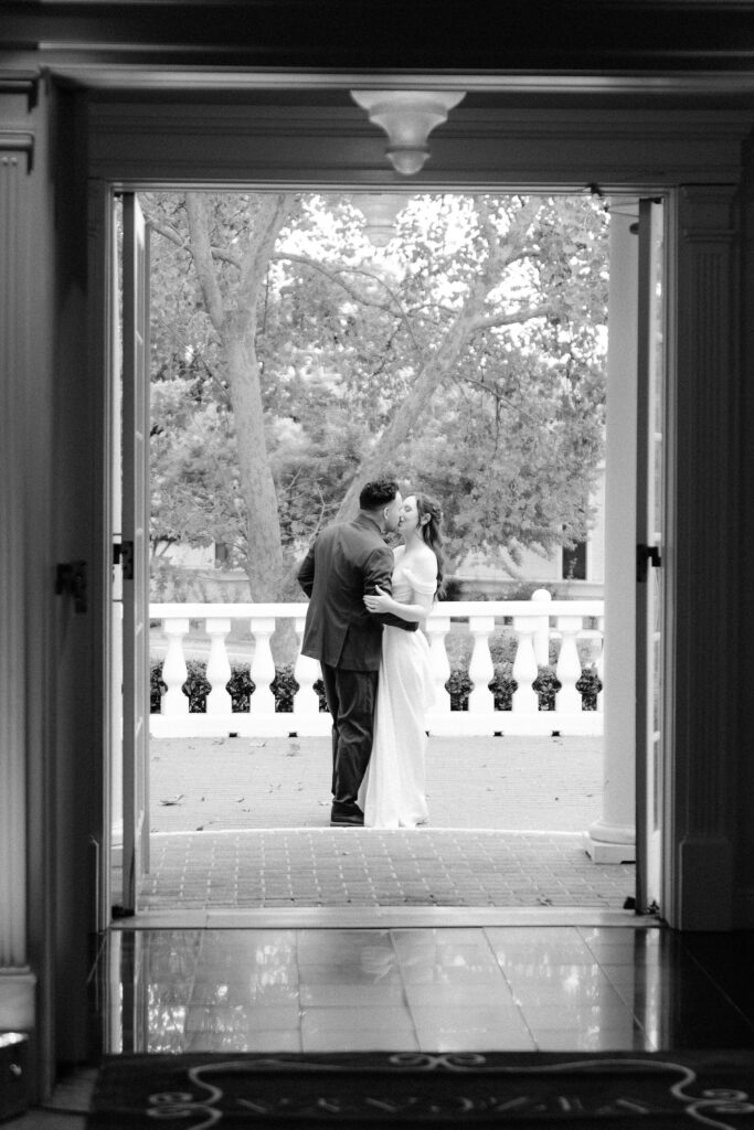 a bride and groom share a quick intimate moment before their reception entrance at Vizcaya photographed by Sacramento wedding photographers