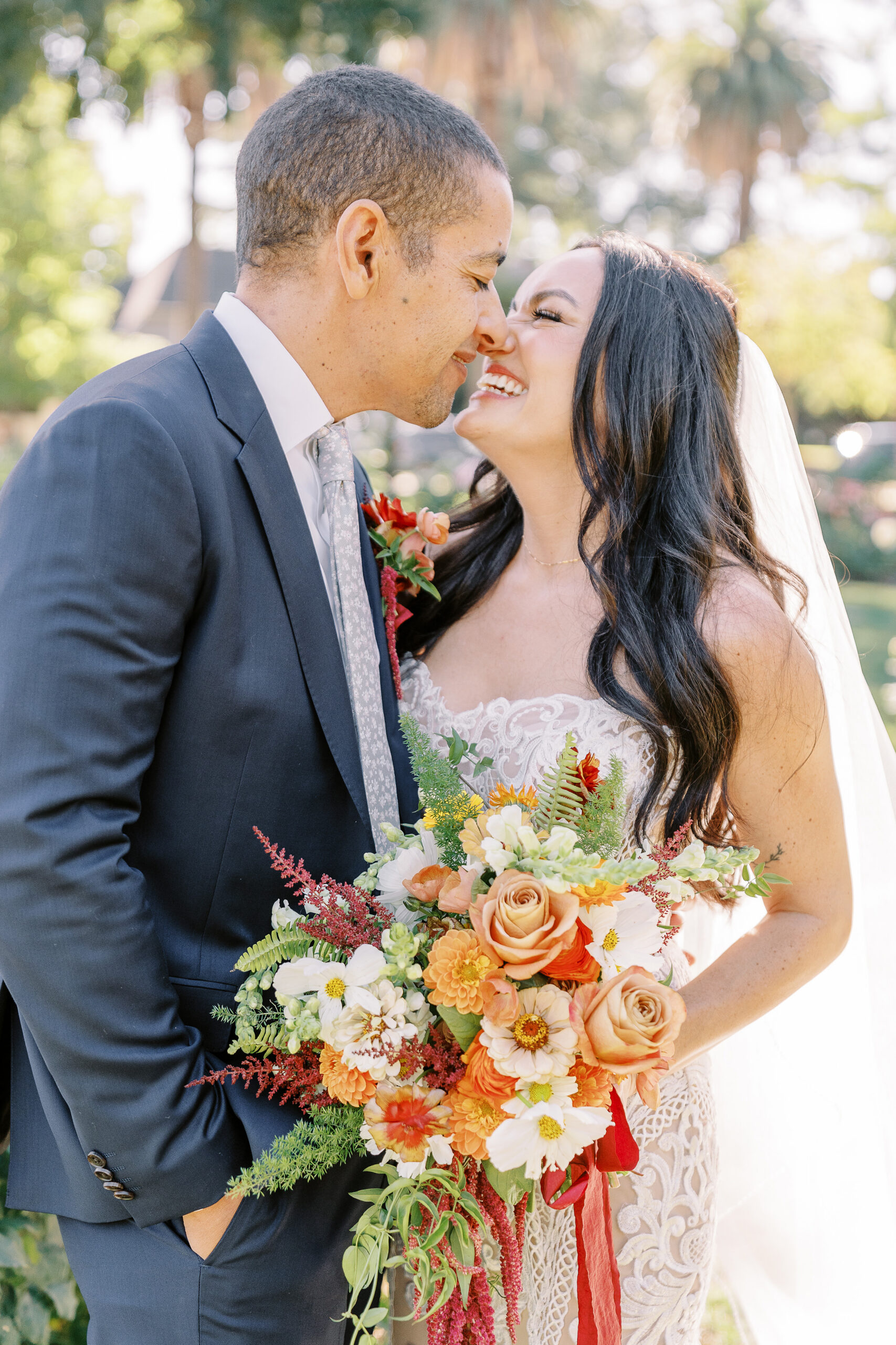 a bride and groom laugh together at their midtown Sacramento wedding photographed by Sacramento wedding photographer