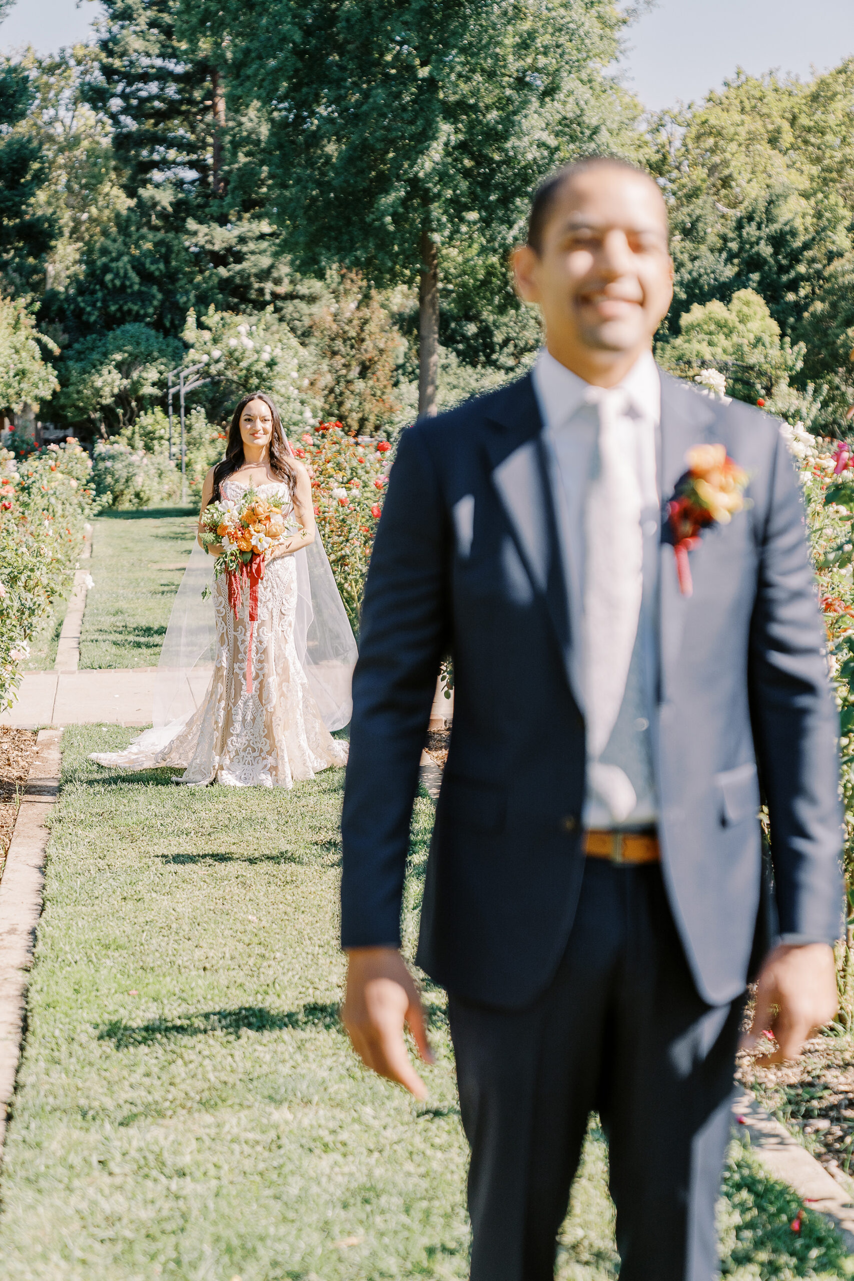 a bride surprises her groom during their first look at their McKinley Park Rose Garden for their midtown Sacramento wedding photographed by Sacramento wedding photographer