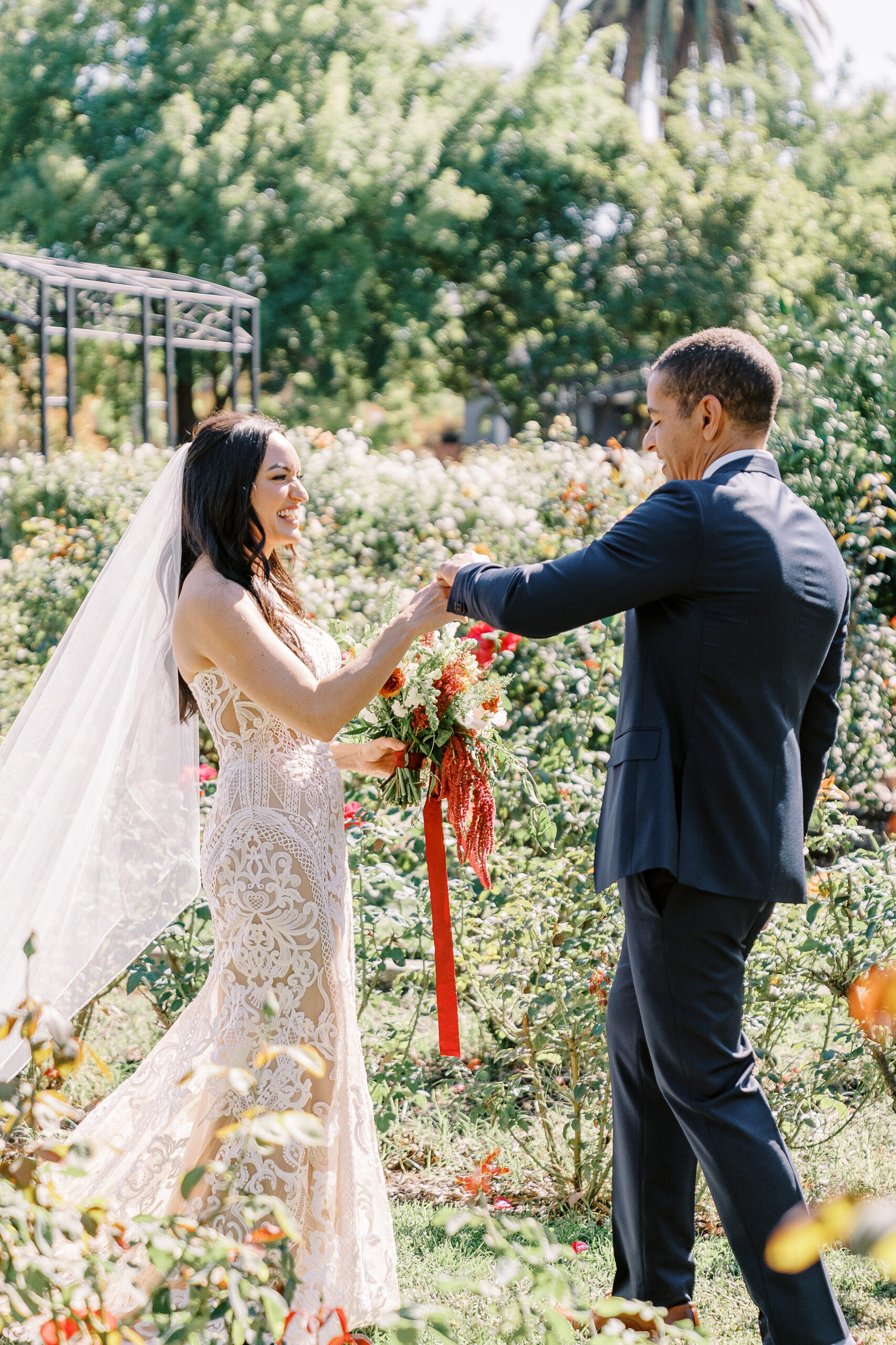 a bride surprises her groom during their first look at their McKinley Park Rose Garden for their midtown Sacramento wedding photographed by Sacramento wedding photographer
