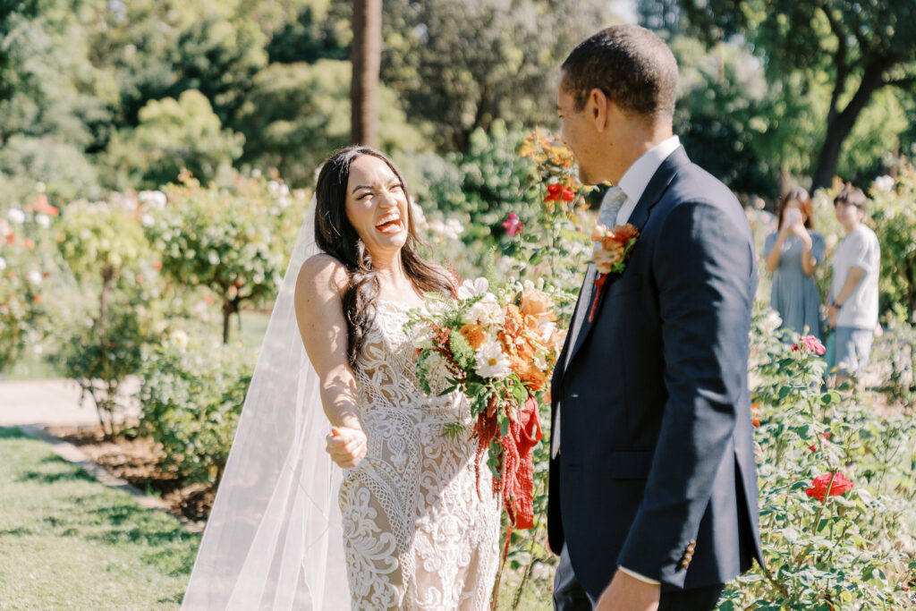 a bride surprises her groom during their first look at their McKinley Park Rose Garden for their midtown Sacramento wedding photographed by Sacramento wedding photographer