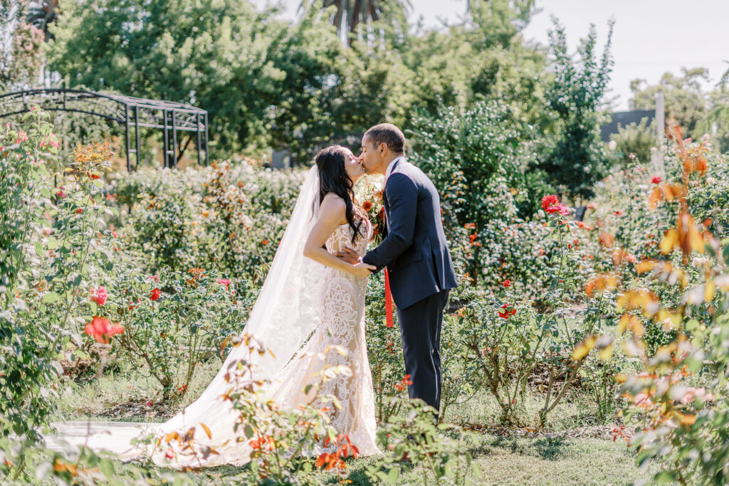 a bride surprises her groom during their first look at their McKinley Park Rose Garden for their midtown Sacramento wedding photographed by Sacramento wedding photographer