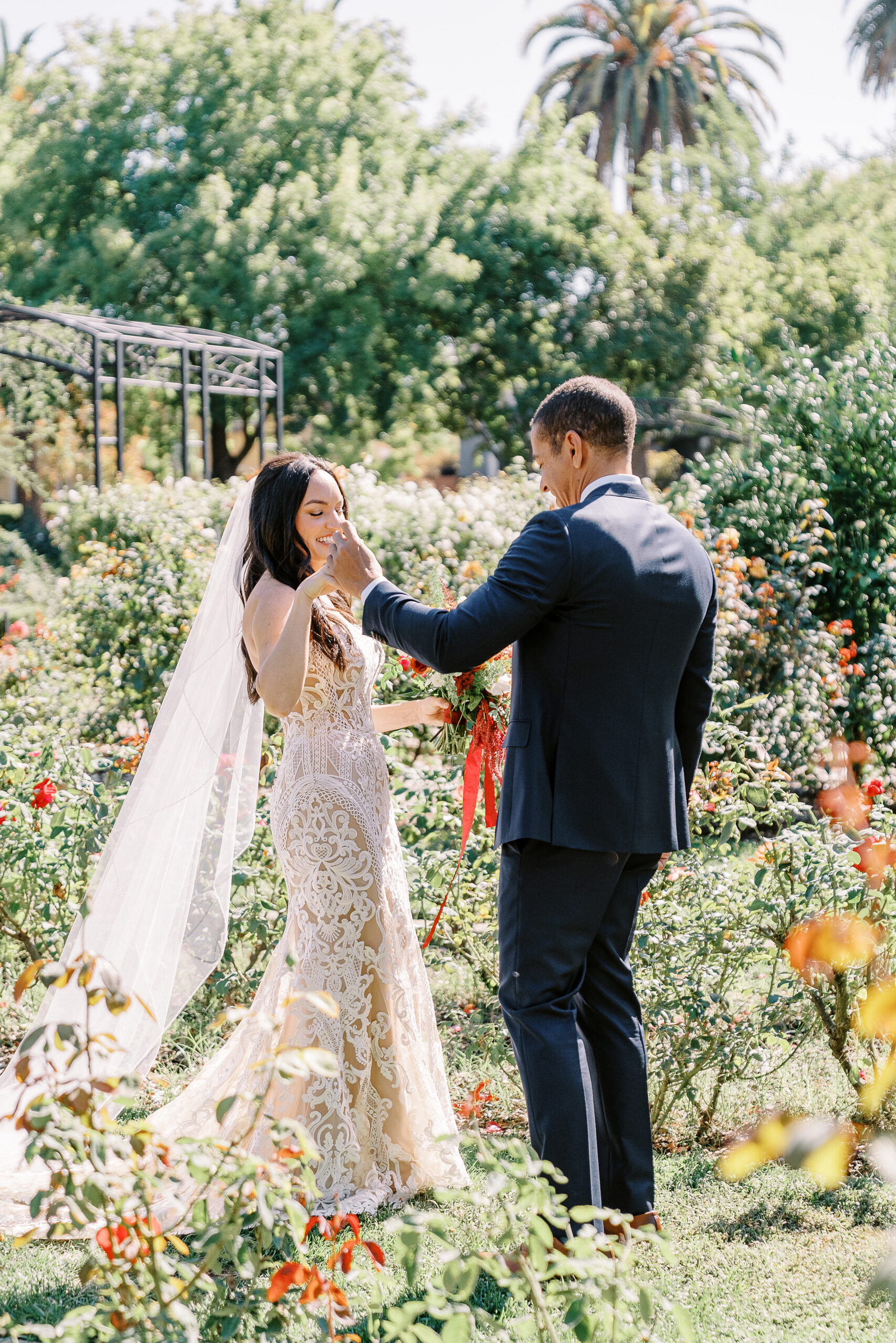 a bride surprises her groom during their first look at their McKinley Park Rose Garden for their midtown Sacramento wedding photographed by Sacramento wedding photographer