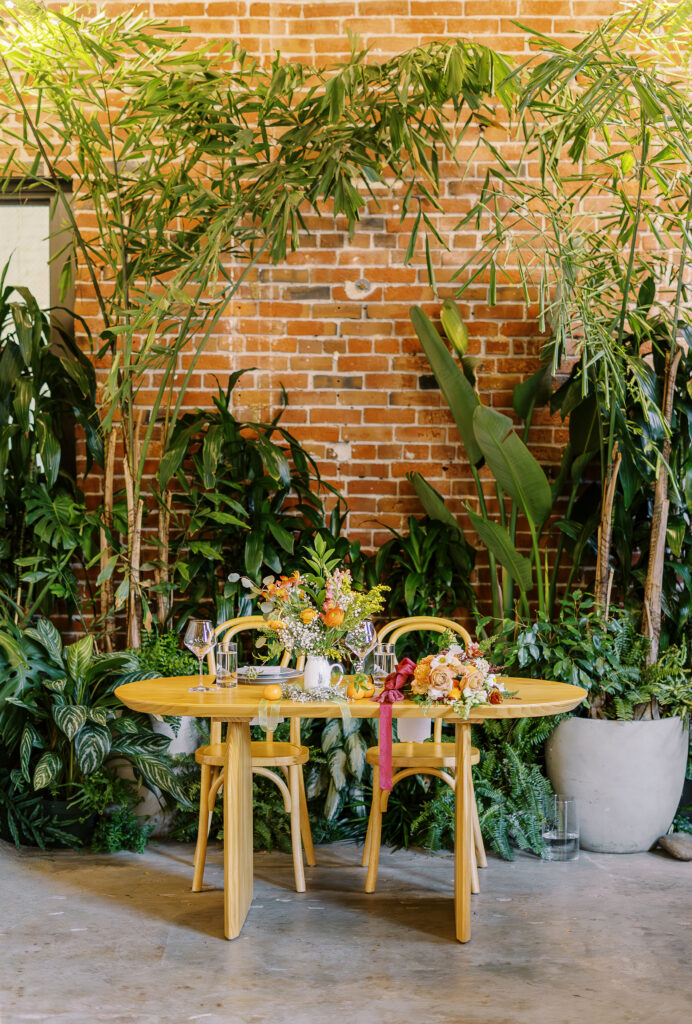 orange and plant themed wedding reception and ceremony decor at a midtown Sacramento wedding photographed by Sacramento wedding photographer