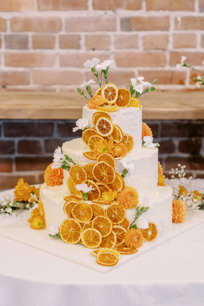 orange and plant themed wedding reception and ceremony decor at a midtown Sacramento wedding photographed by Sacramento wedding photographer